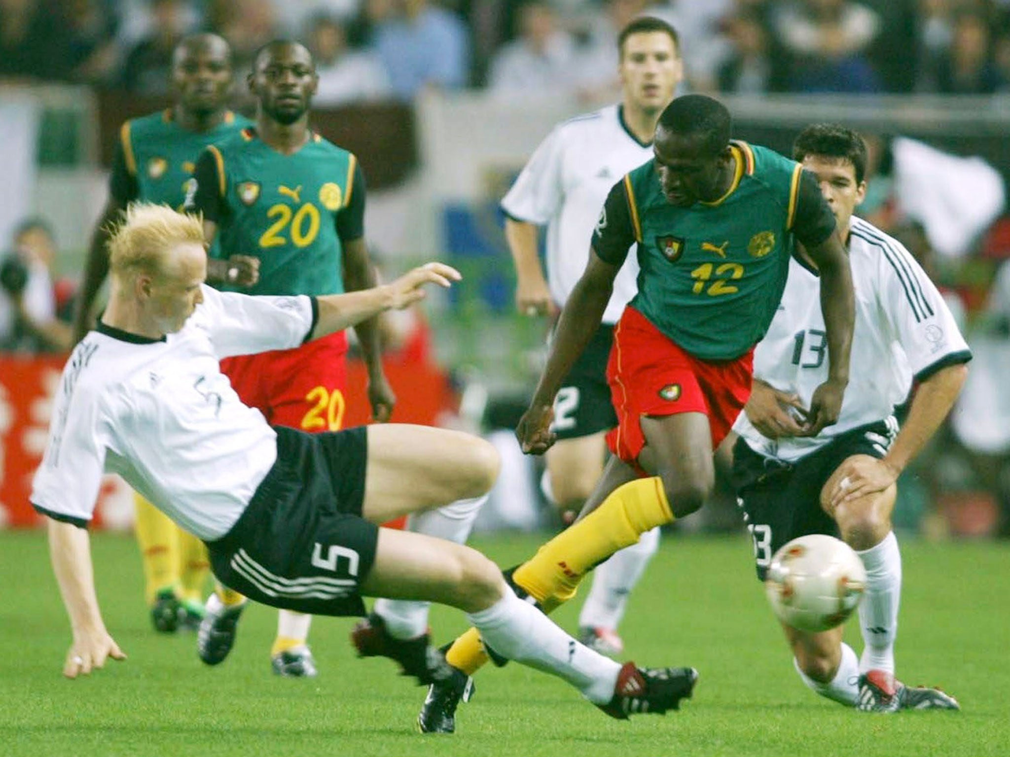 Lauren rides a challenge from Germany's Carsten Ramelow at the 2002 World Cup