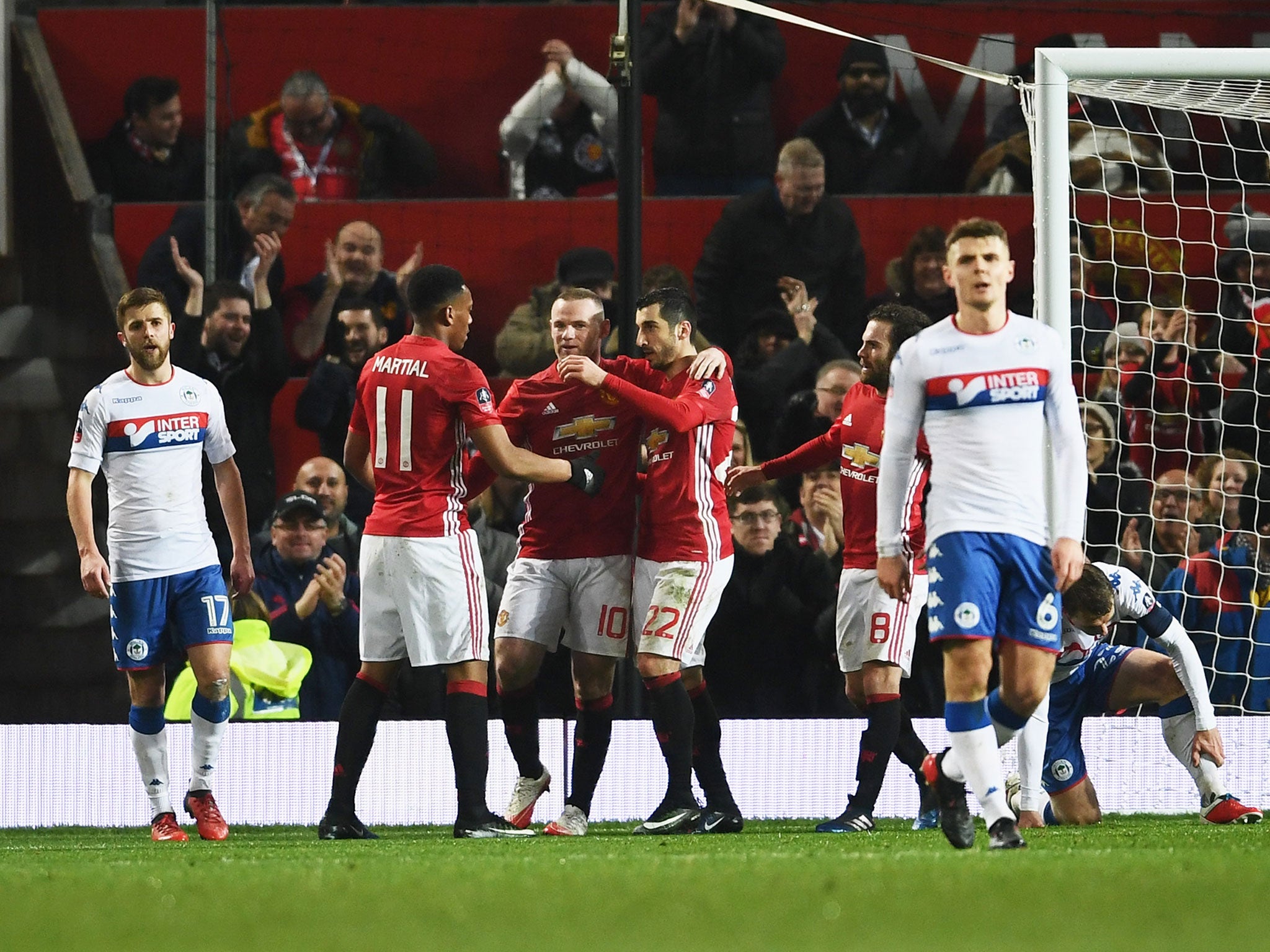 Henrikh Mkhitaryan is congratulated by his team mates after scoring United's third