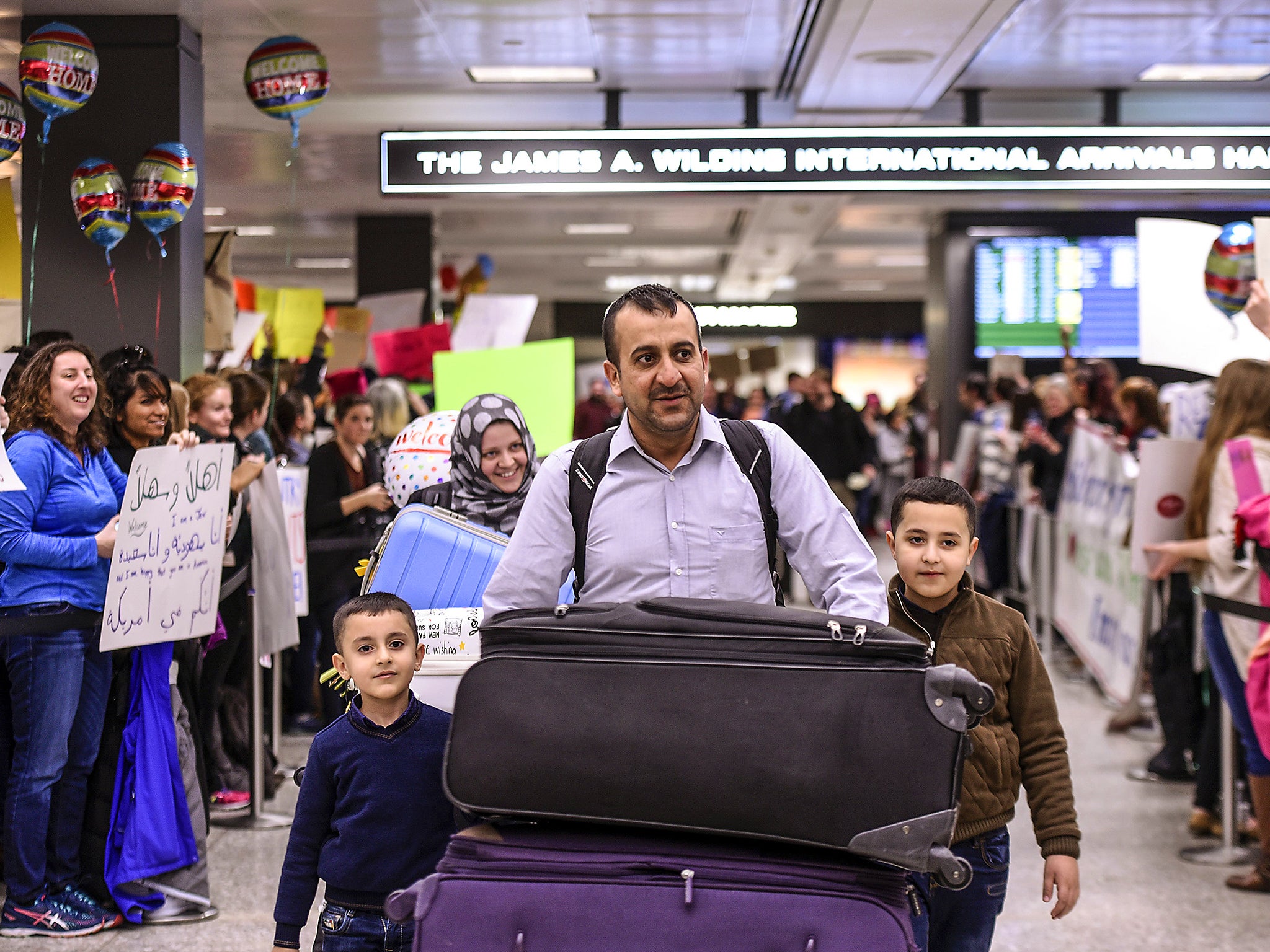 Protestors rally during a demonstration against the Muslim immigration ban at Dulles International Airport in Sterling