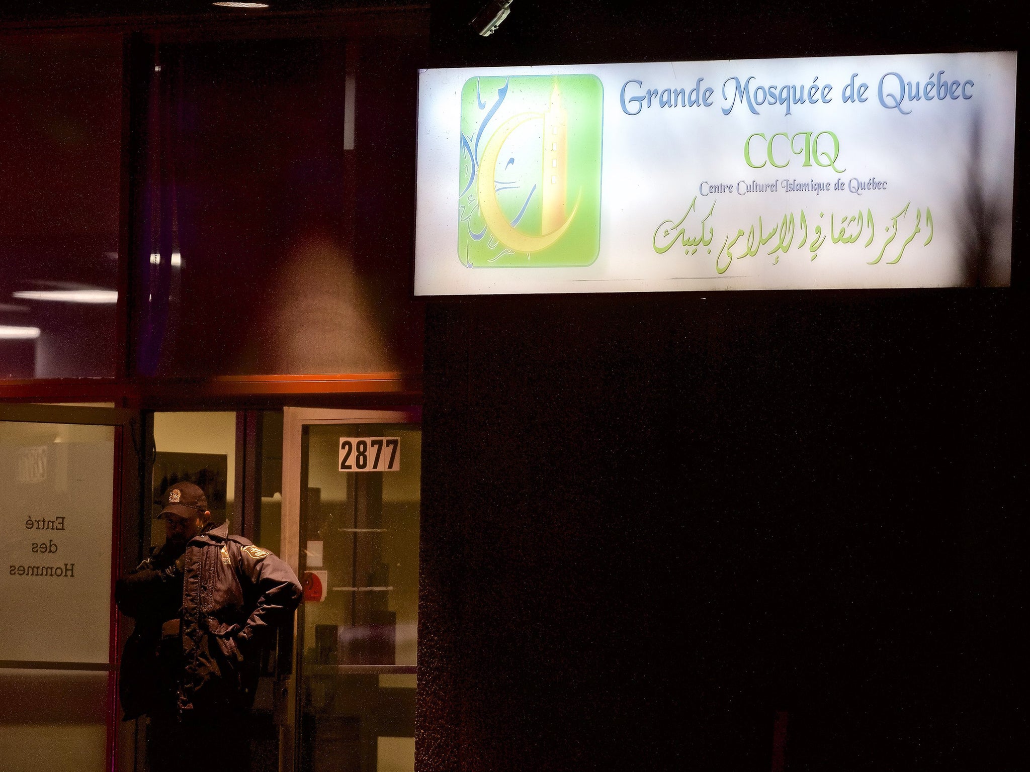 A Quebec police officer stands guard after the shooting