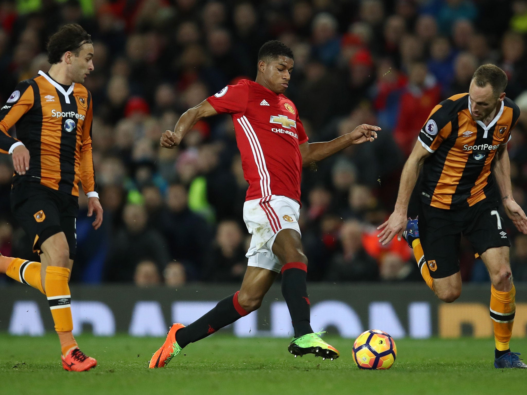 Marcus Rashford is closed down by David Meyler and Lazar Markovic