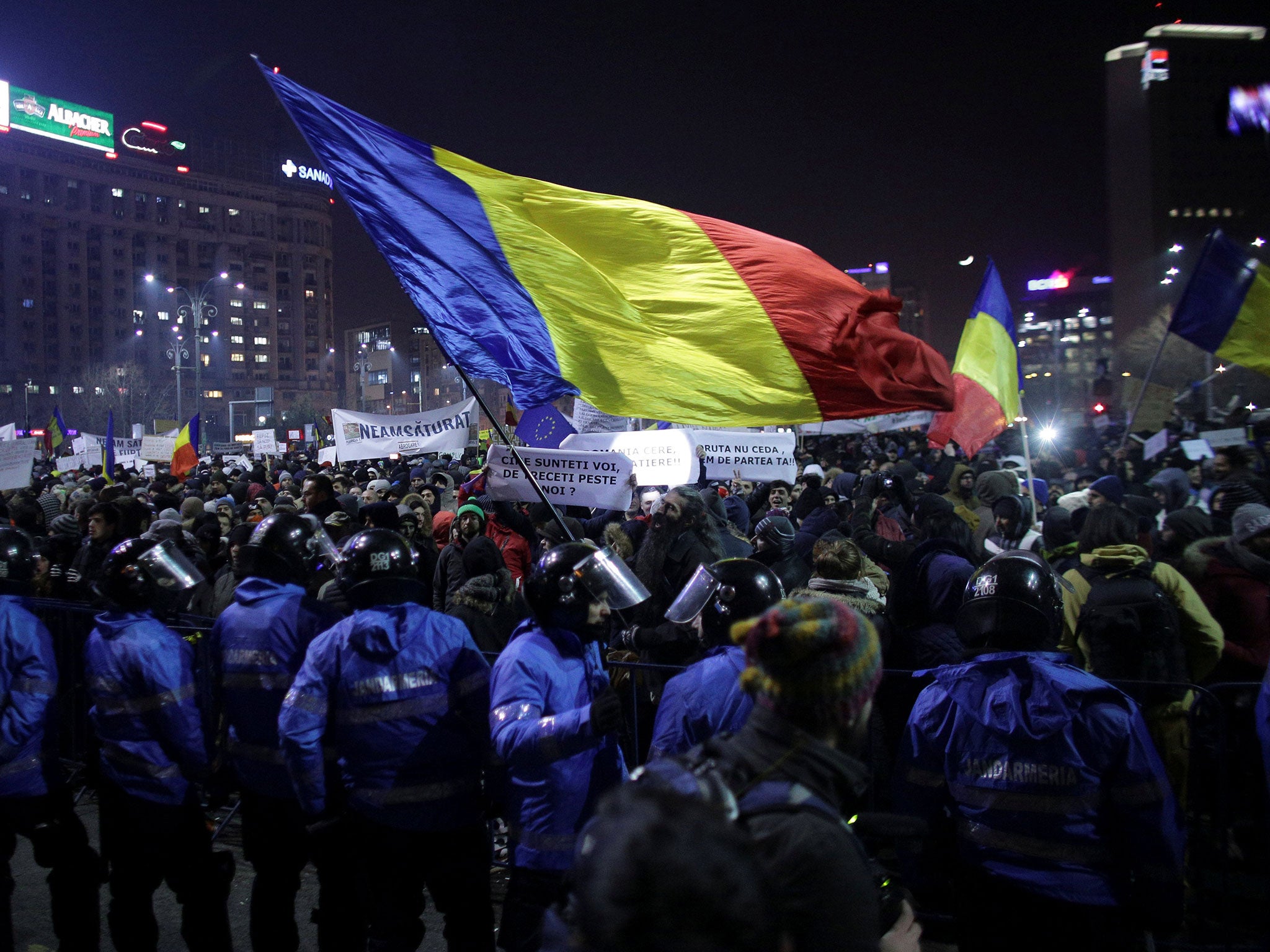 Protesters wave a Romanian flag during a demonstration in Bucharest, Romania, 1 February, 2017