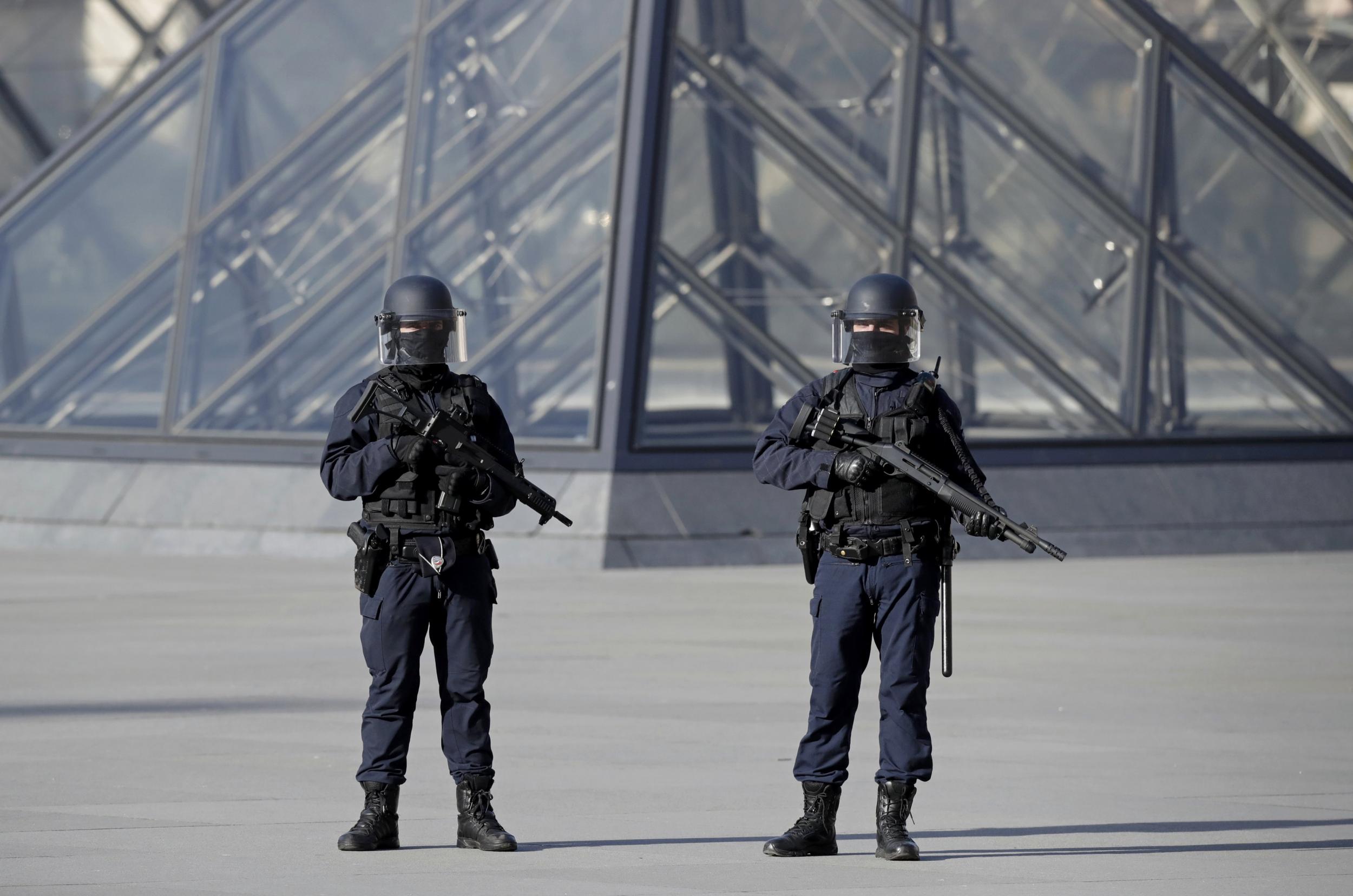 French police secure the site near the Louvre Pyramid in Paris