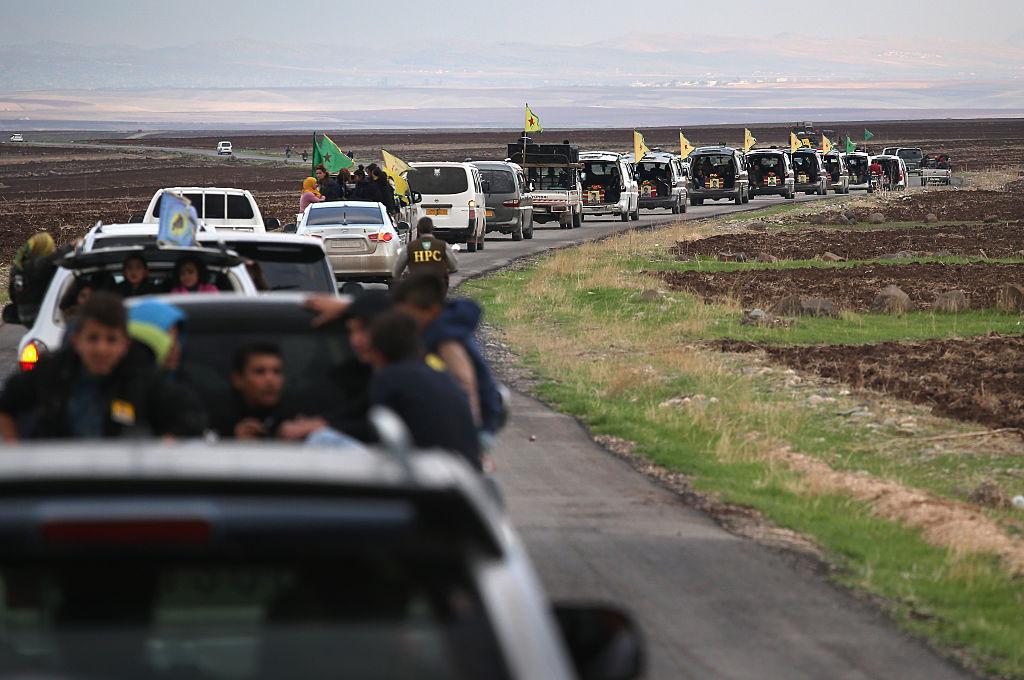 A funeral procession carries eight members of the People's Protection Units (YPG), to a martyrs' cemetery on November 8, 2015 in Rojava, Syria. The YPG are among several forces pushing Isis back towards their stronghold of Raqqa.