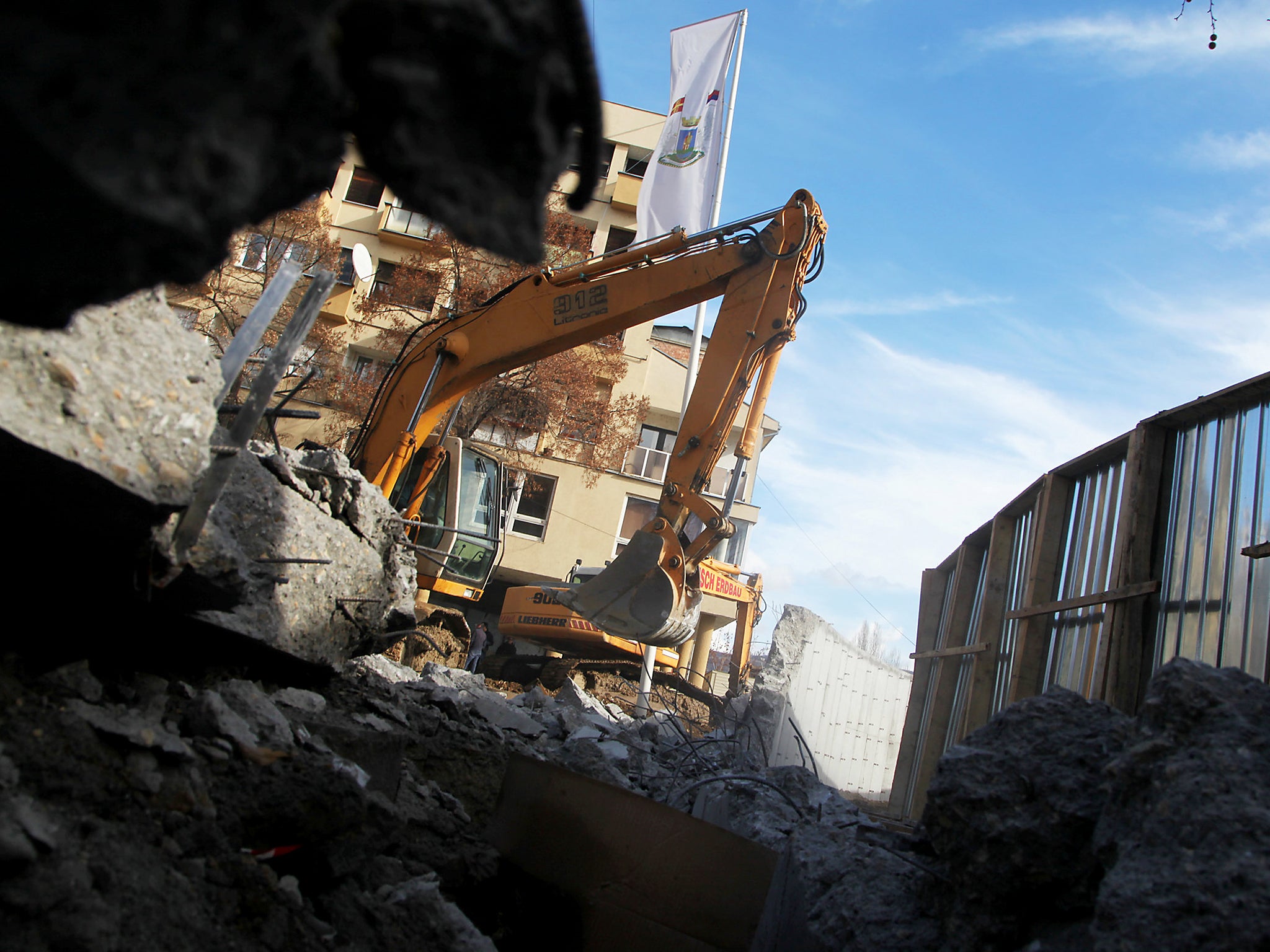 Bulldozers demolish a wall following weeks of tensions between Kosovo and Serbia, in the ethnically divided town of Mitrovica, Kosovo