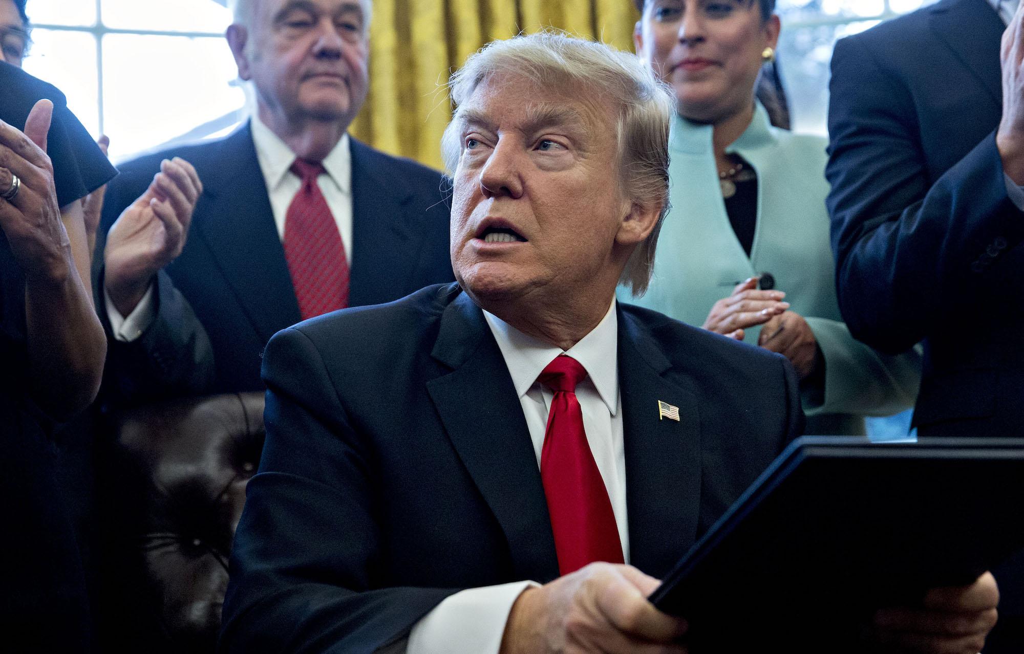 President Trump sings an executive order in the Oval Office on January 30, 2017 in Washington, DC.