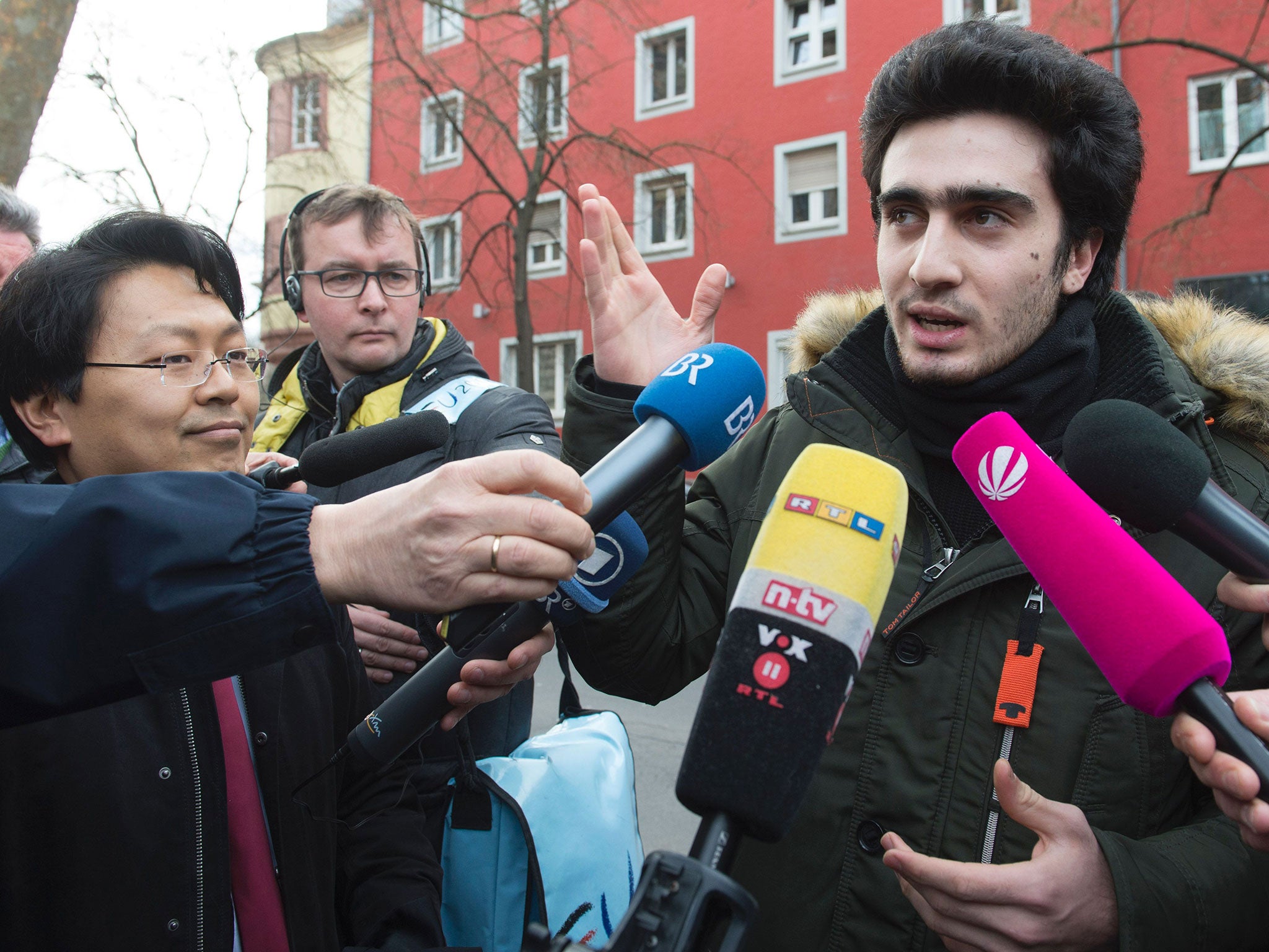 Syrian refugee Anas Modamani and his lawyer Chan-jo Jun at the district court in Wurzburg, Germany, on 6 Februaru