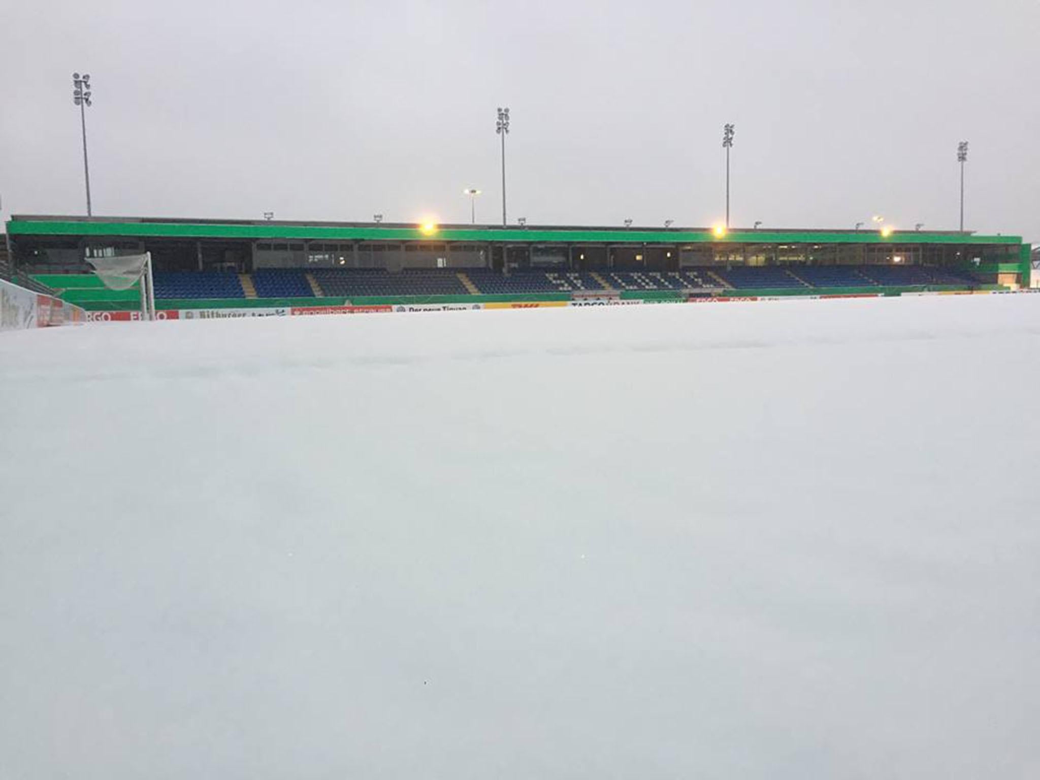 The pitch was covered in several centimetres of snow on Wednesday morning