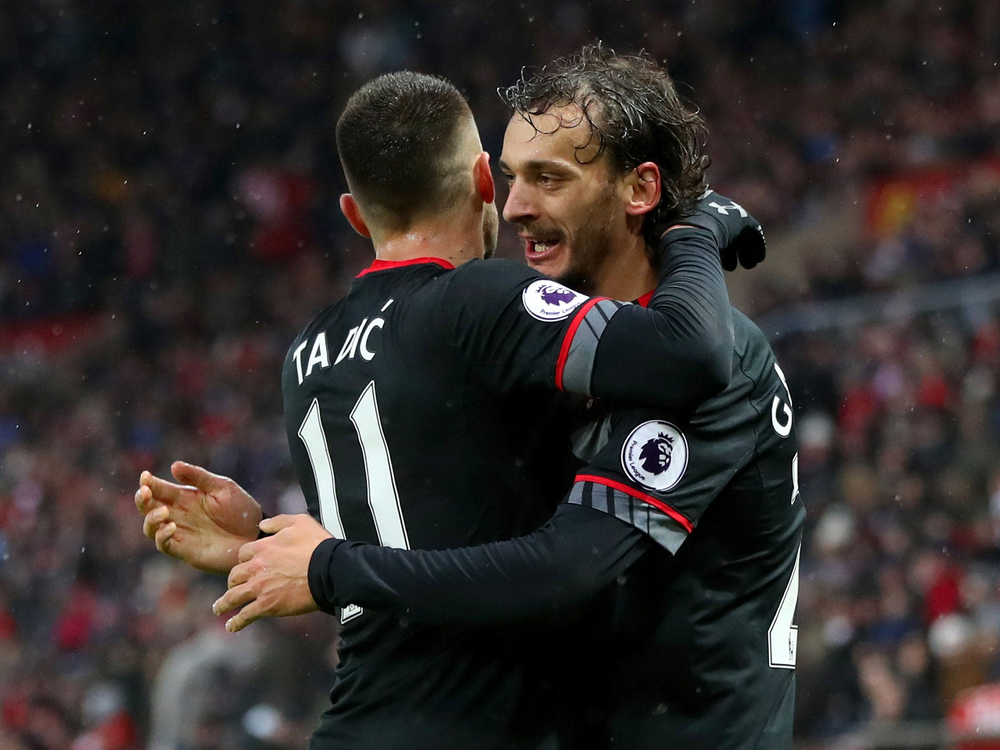 Manolo Gabbiadini celebrates with Dusan Tadic after bagging his second