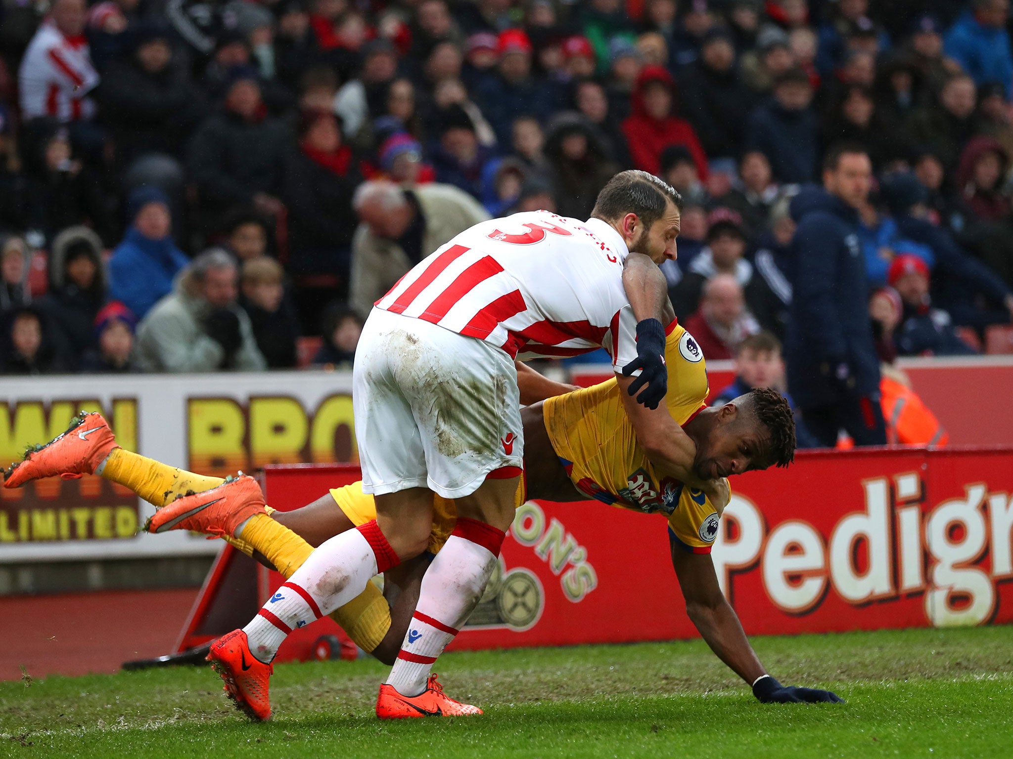 Wilfried Zaha and Erik Pieters tussle as they fall to the ground