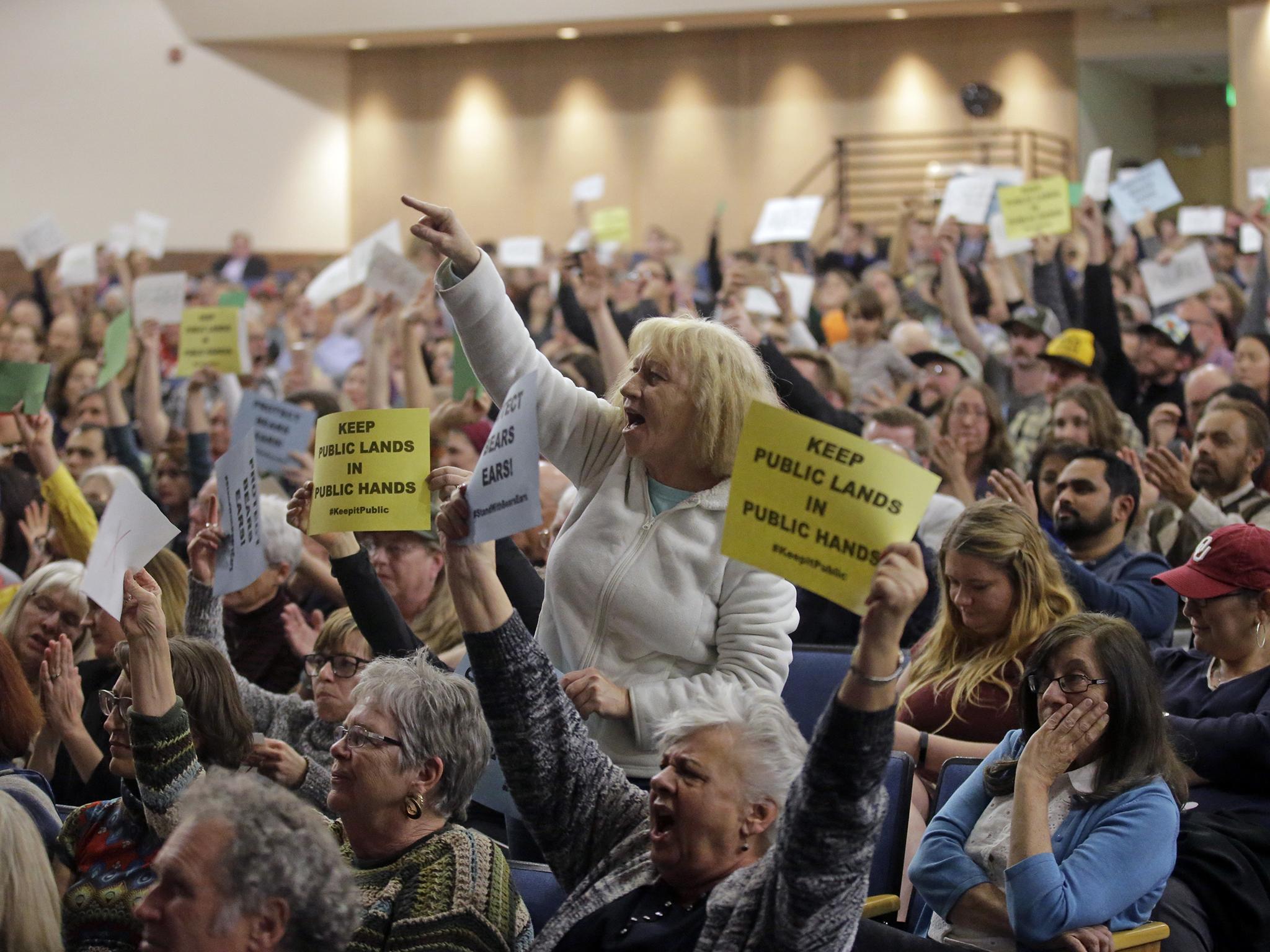 Tami Sablan shouts as Chaffetz speaks during a town hall meeting at Brighton High School