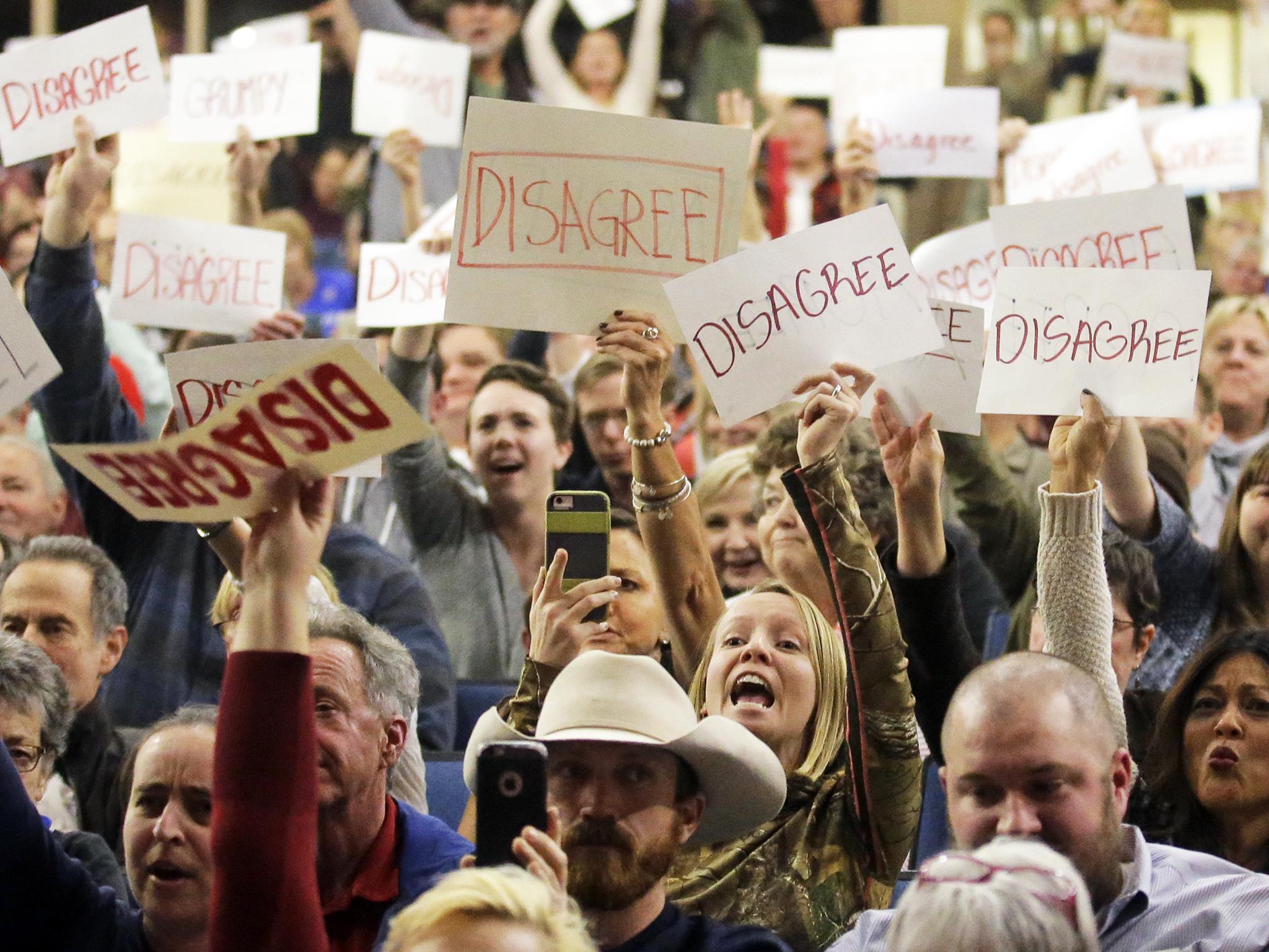 Audience shouts down Republican Jason Chaffetz who was reluctant to investigate Mr Trump's conflicts of interest