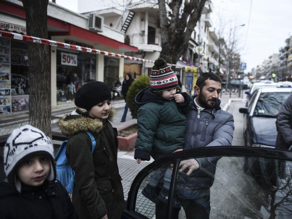 Residents of Kordelio district board a taxi after authorities ordered the evacuation of the area in order to defuse a 500-pound unexploded World War II bomb, in Thessaloniki, Greece