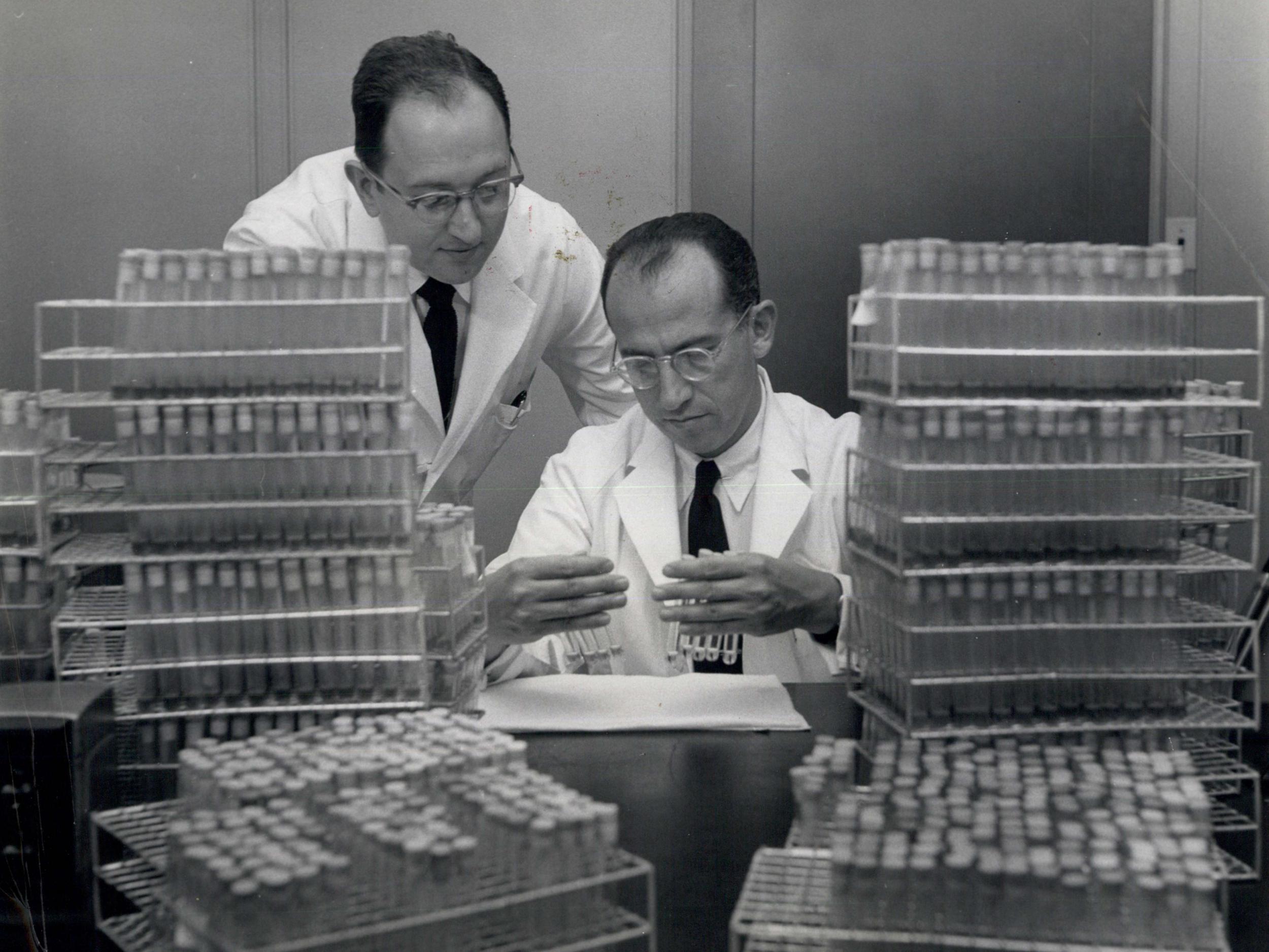 Dr Jonas Salk, who developed the injectable polio vaccine, in the lab with his assistant (Rex)