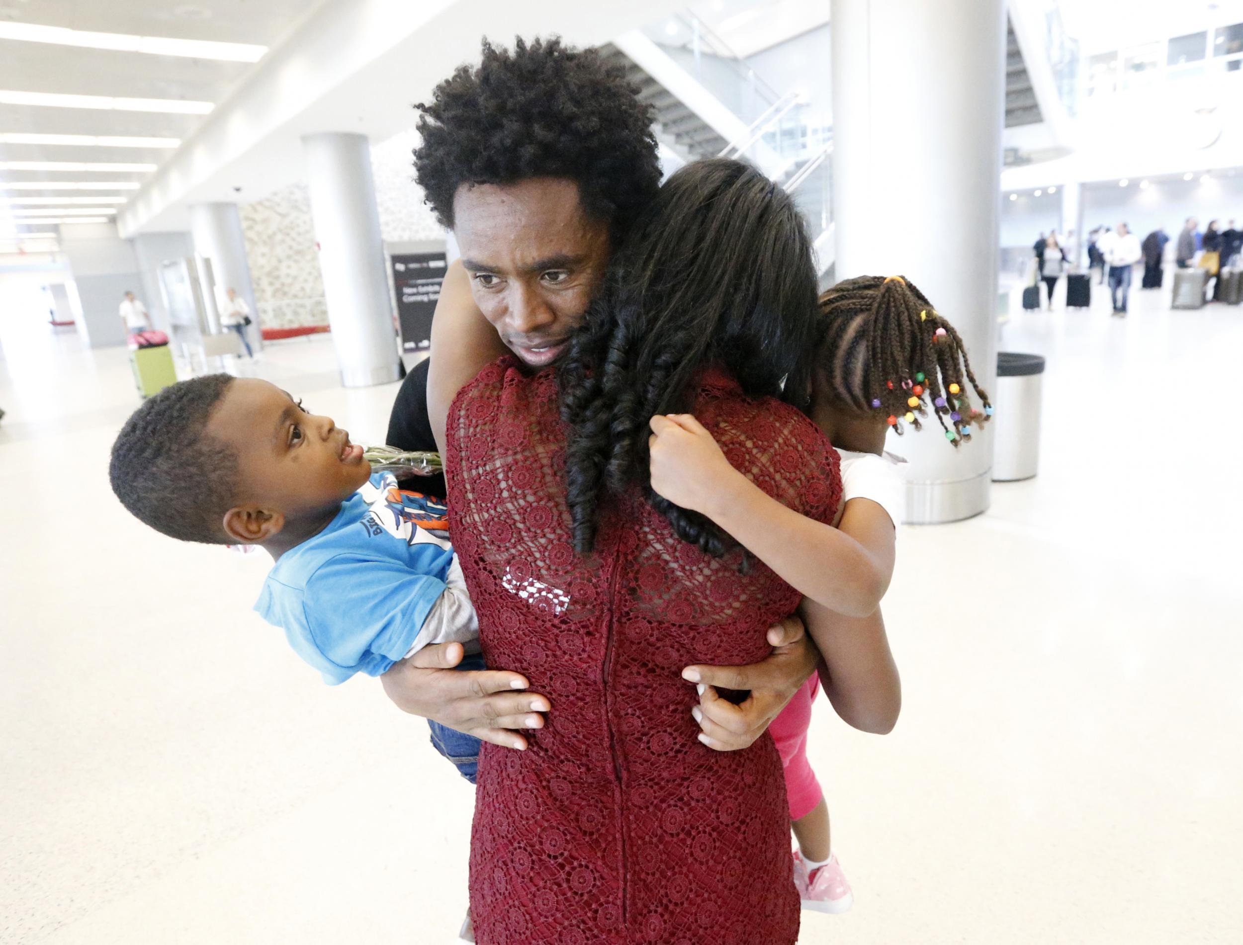 Feyisa Lilesa greets his wife and two children