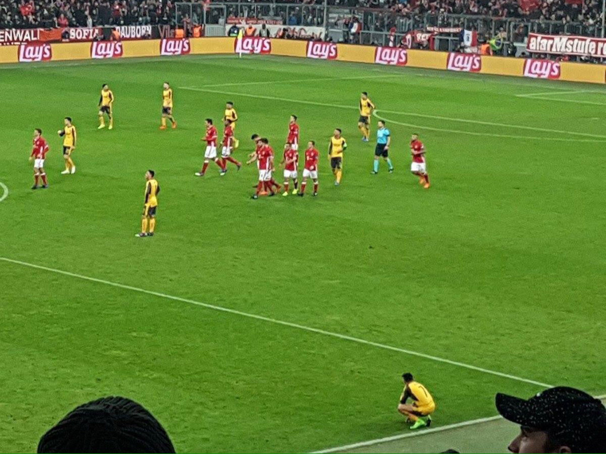 Alexis Sanchez crouches on his own after Thomas Muller scores Bayern Munich's fifth goal against Arsenal