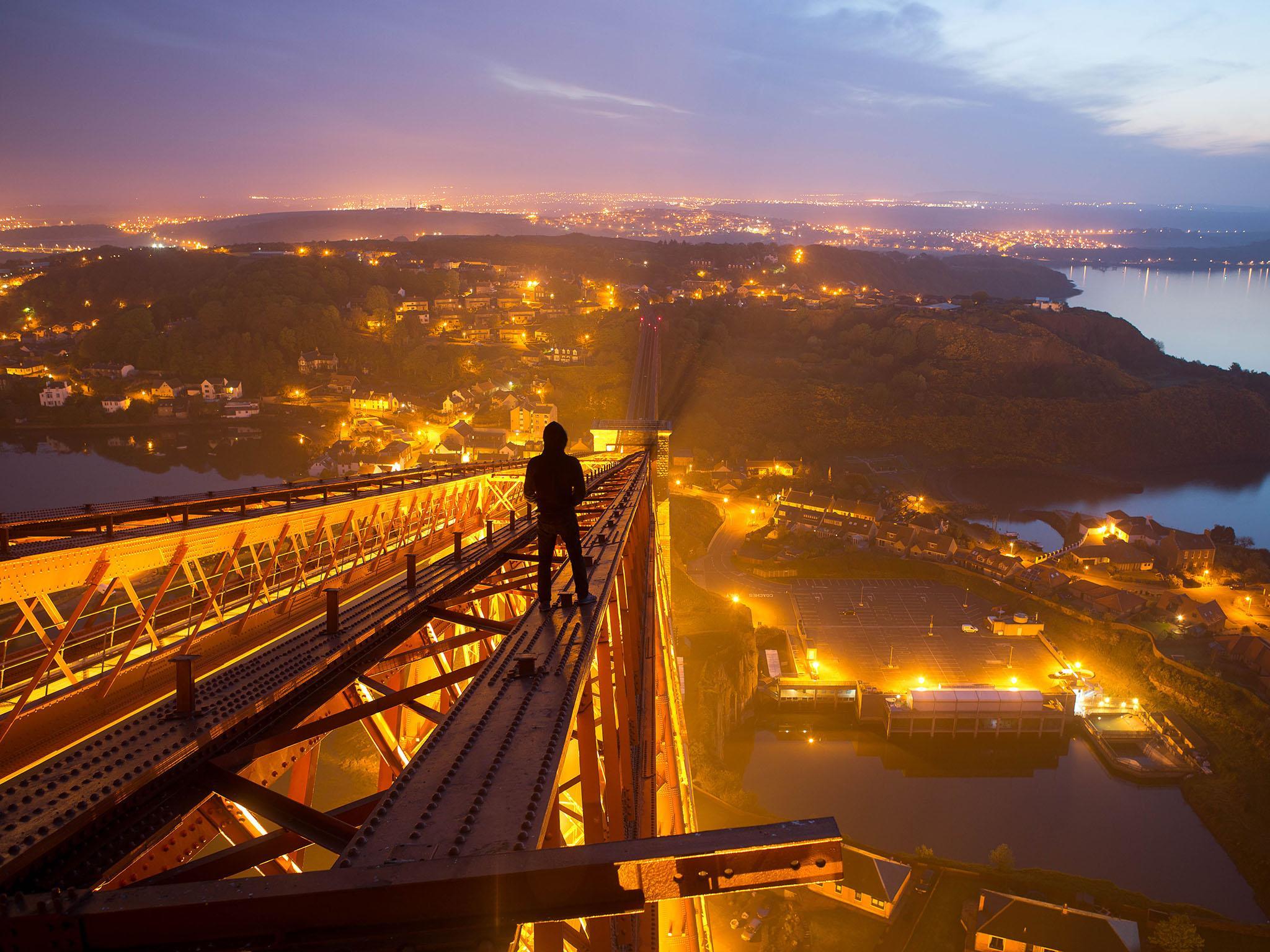 ‘Urban exploring is a calculated risk. When the risk/reward ratio is out of whack, you walk away from it. But the best explorations are right on that line’: urbexer Bradley Garrett surveys Edinburgh from atop the Forth Bridge