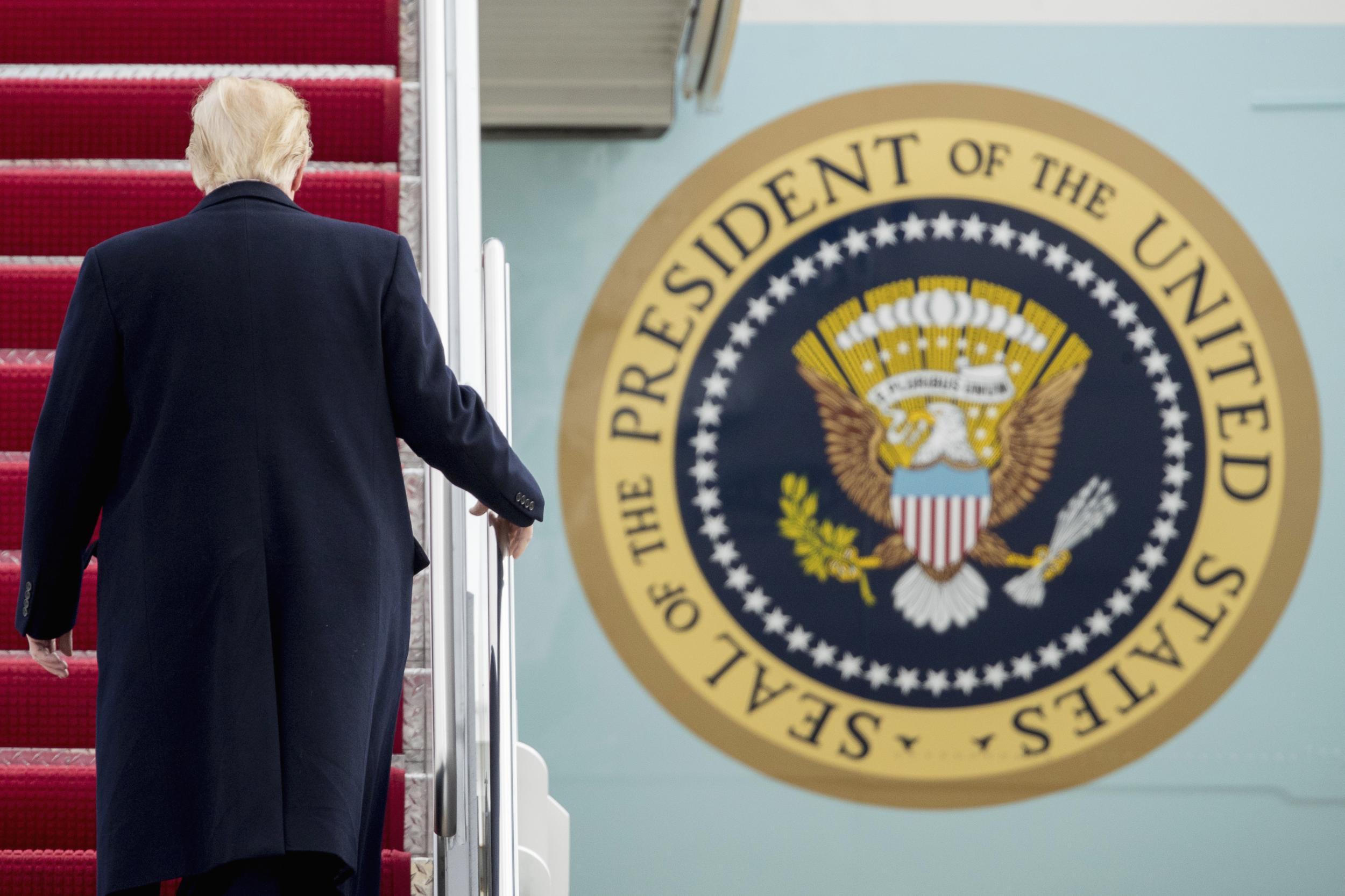 Mr Trump boarding his Boeing Air Force One plane