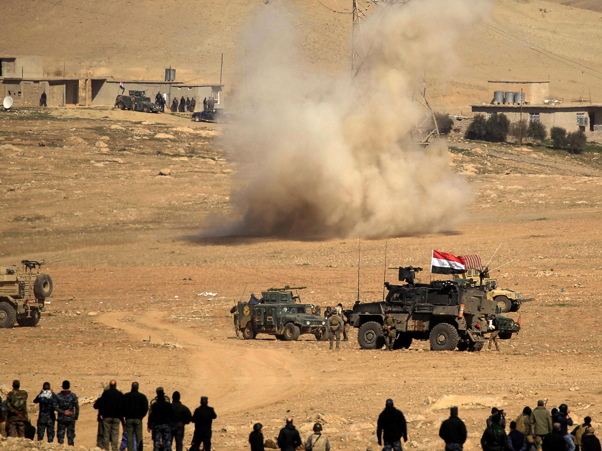 Smoke rises after a rocket landed in the middle of the Iraqi rapid response forces' position during a battle against Isis militants in the south of Mosul, Iraq, 19 February, 2017