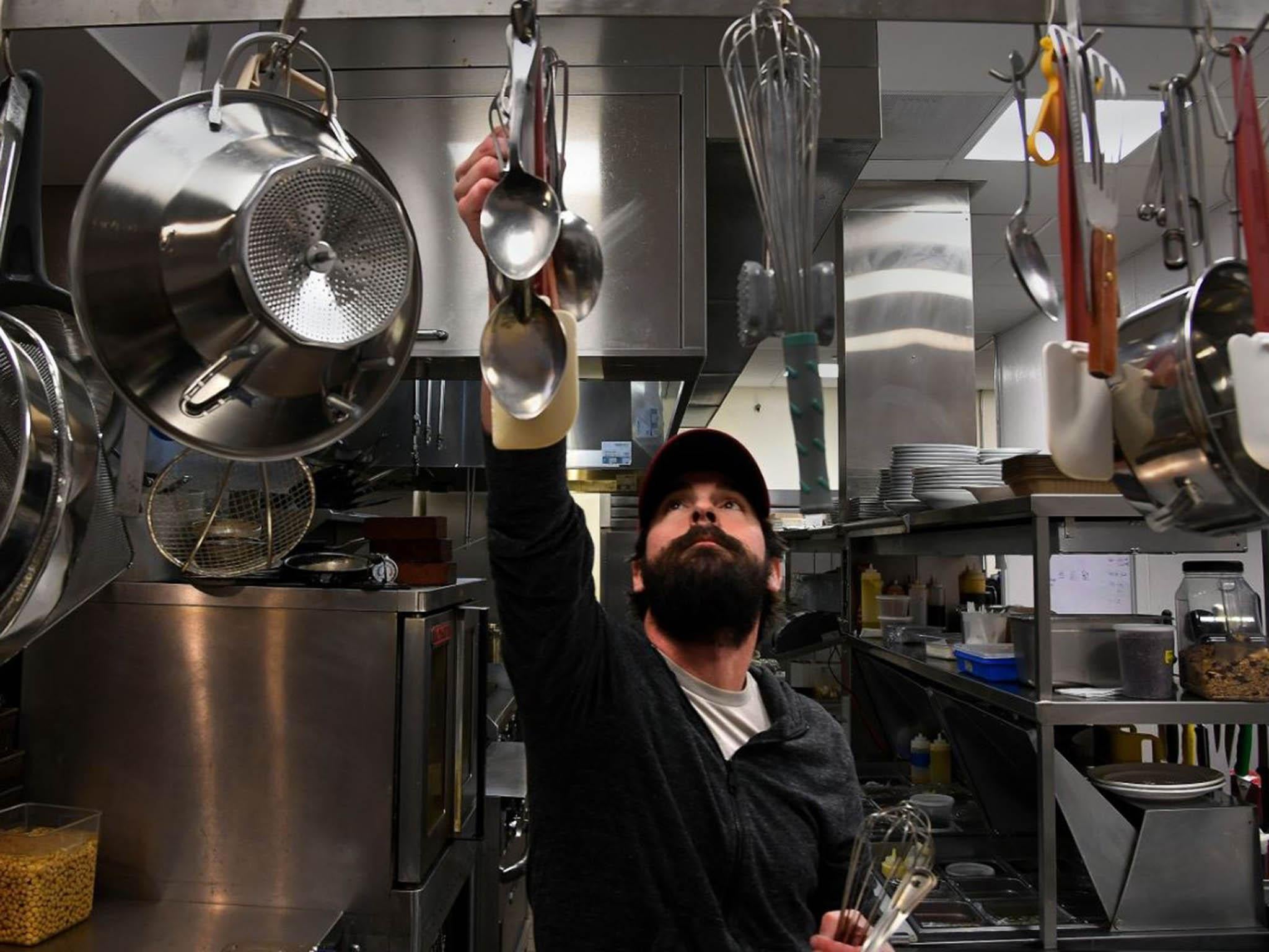 Colin McDonough, co-owner of the Boundary Stone pub, helps prep the line for the dinner shift on Thursday