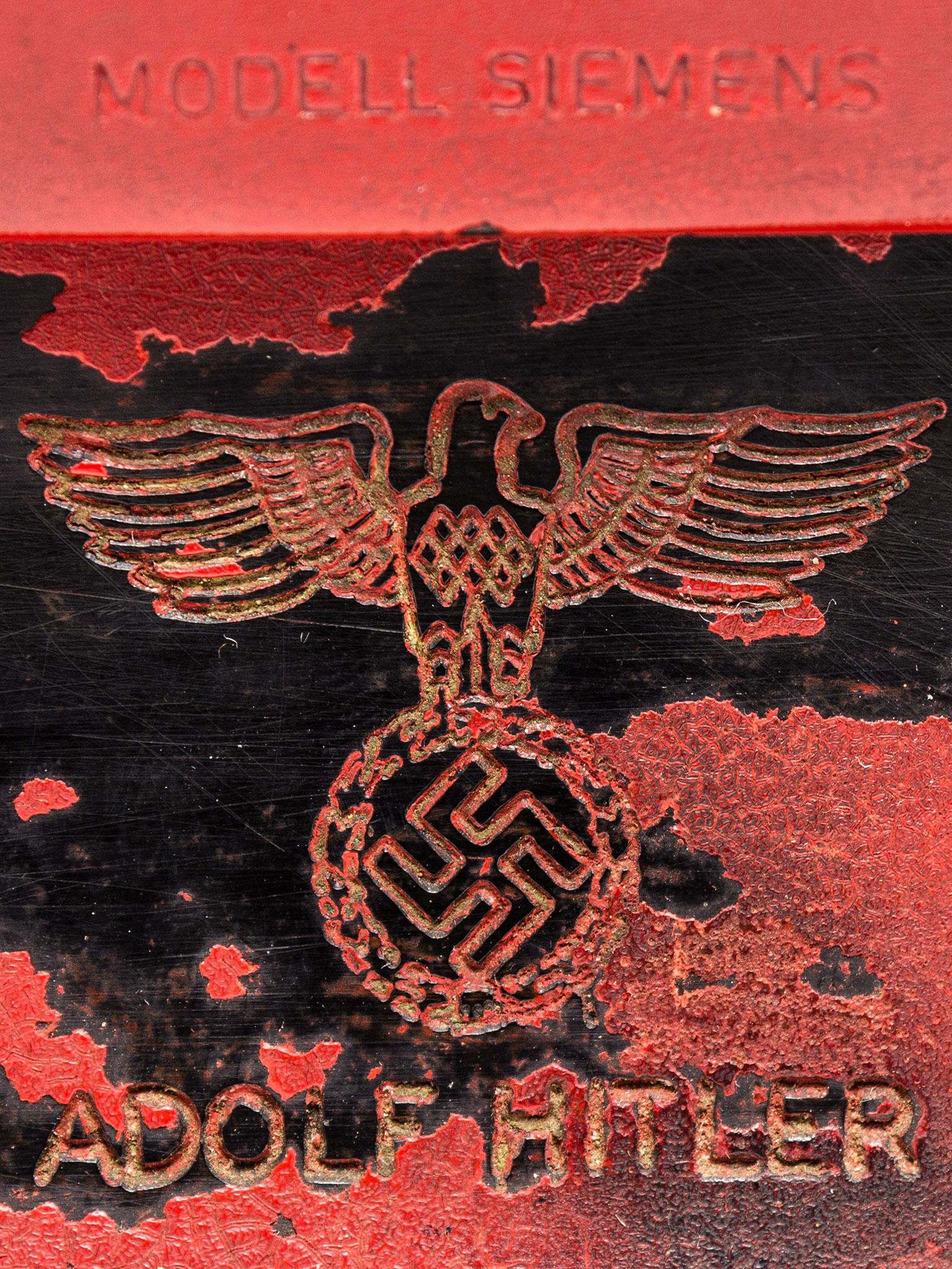 Red phone has the Nazi party symbol and Hitler's name engraved on the back