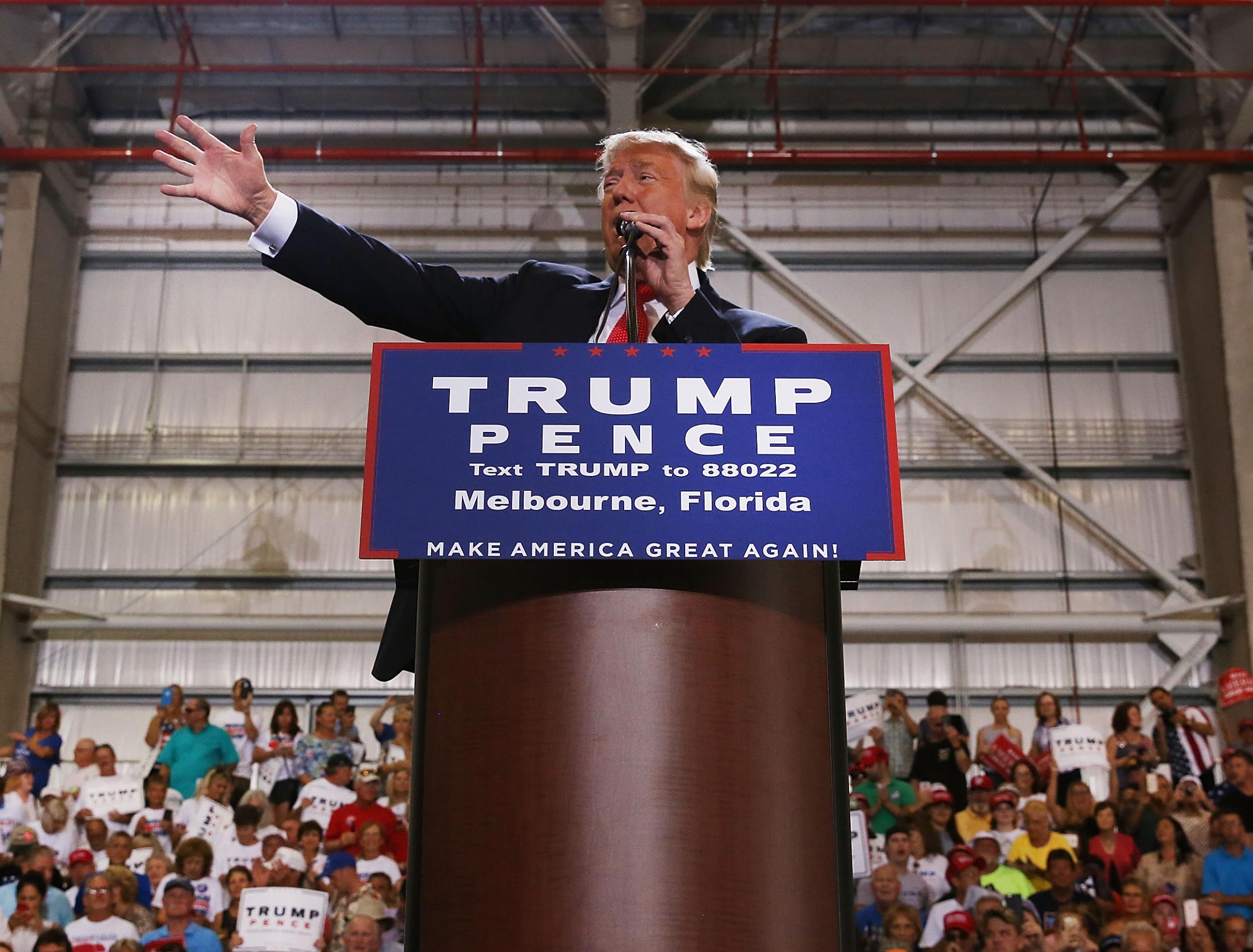 Donald Trump speaks to a large group of supporters at a Florida airport hanger