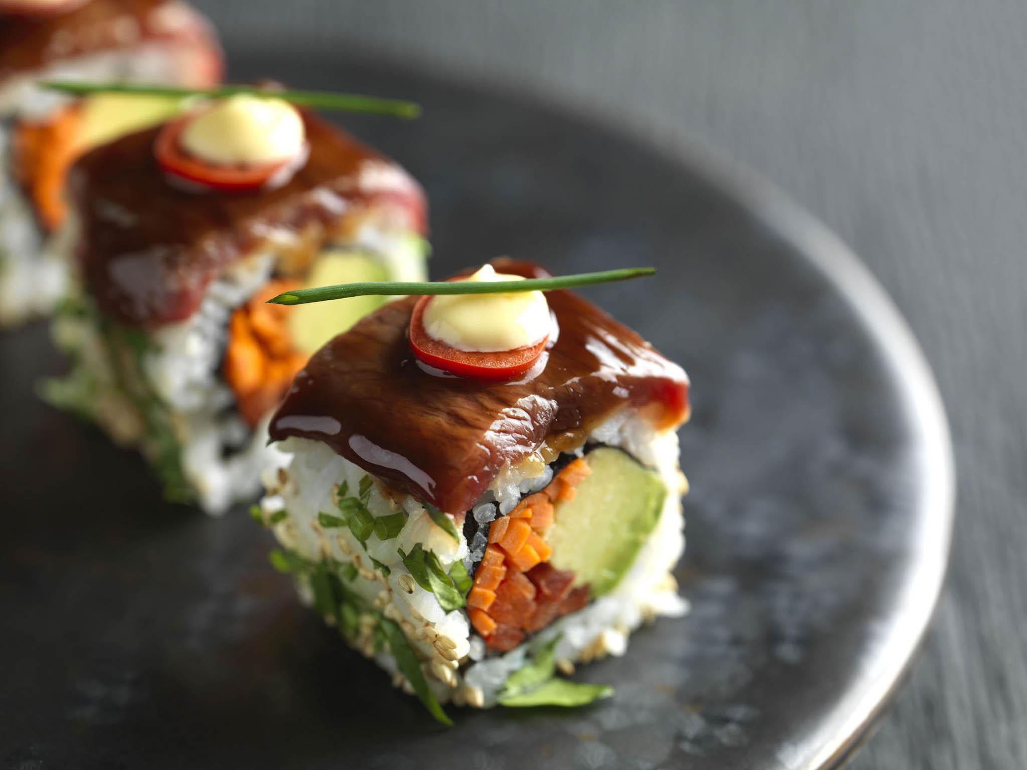 The Gyu special roll uses finely cut beef lacquered with teriyaki sauce on the top of the roll