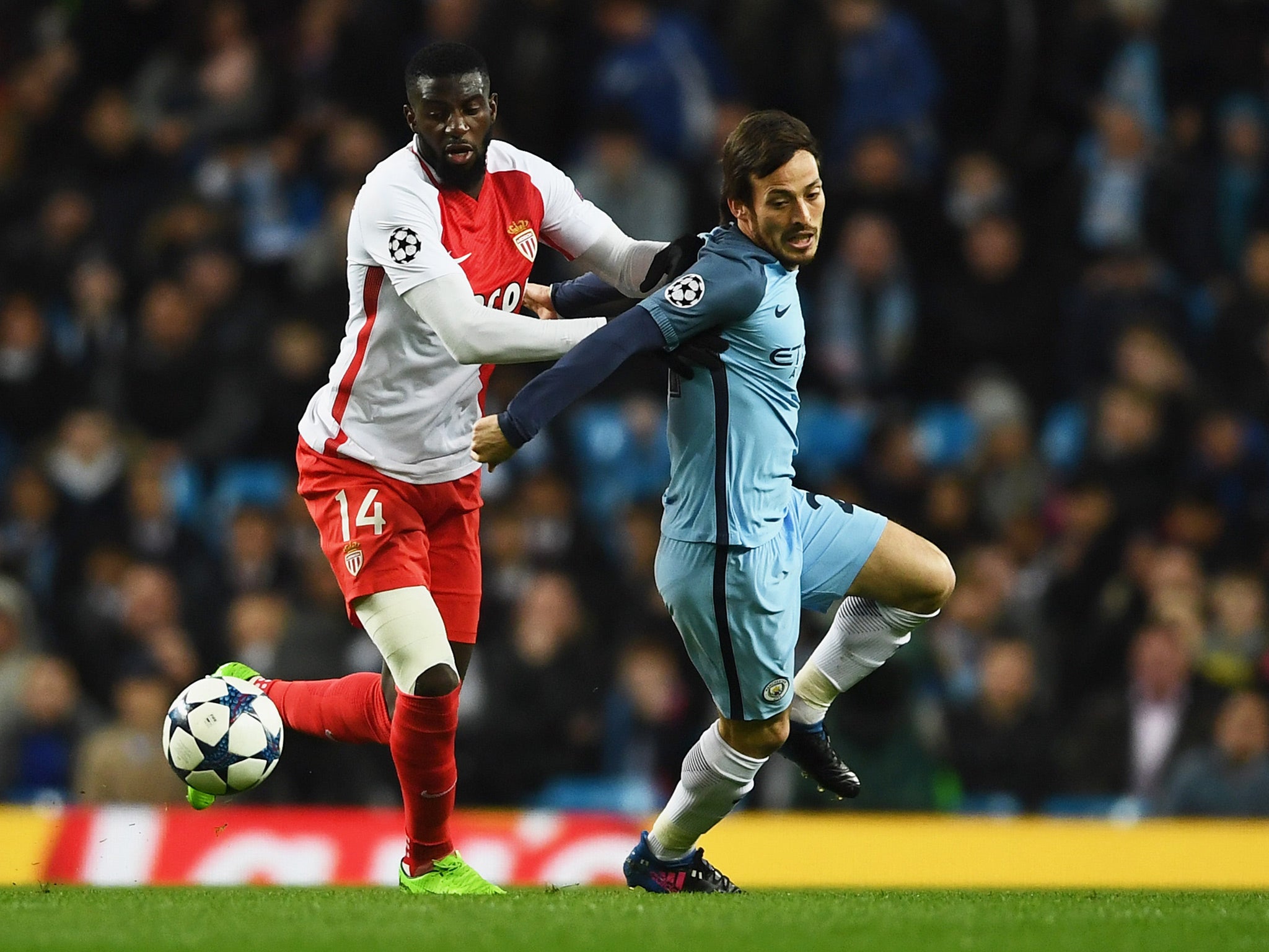 Tiemoue Bakayoko vies for the ball with David Silva at the Etihad Stadium