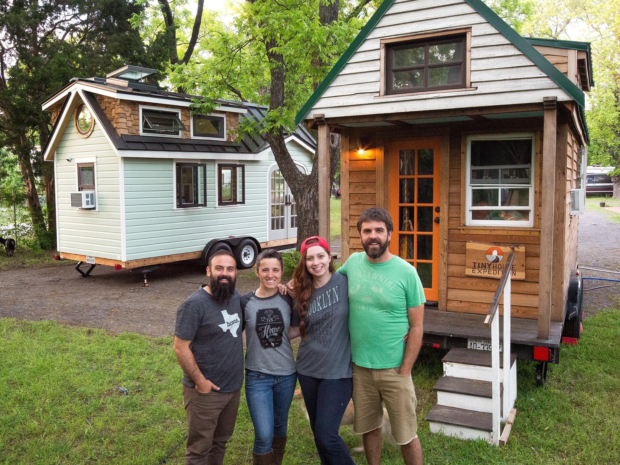 Christian Parsons (right) and Alexis Stephens (second right) outside their tiny home on wheels