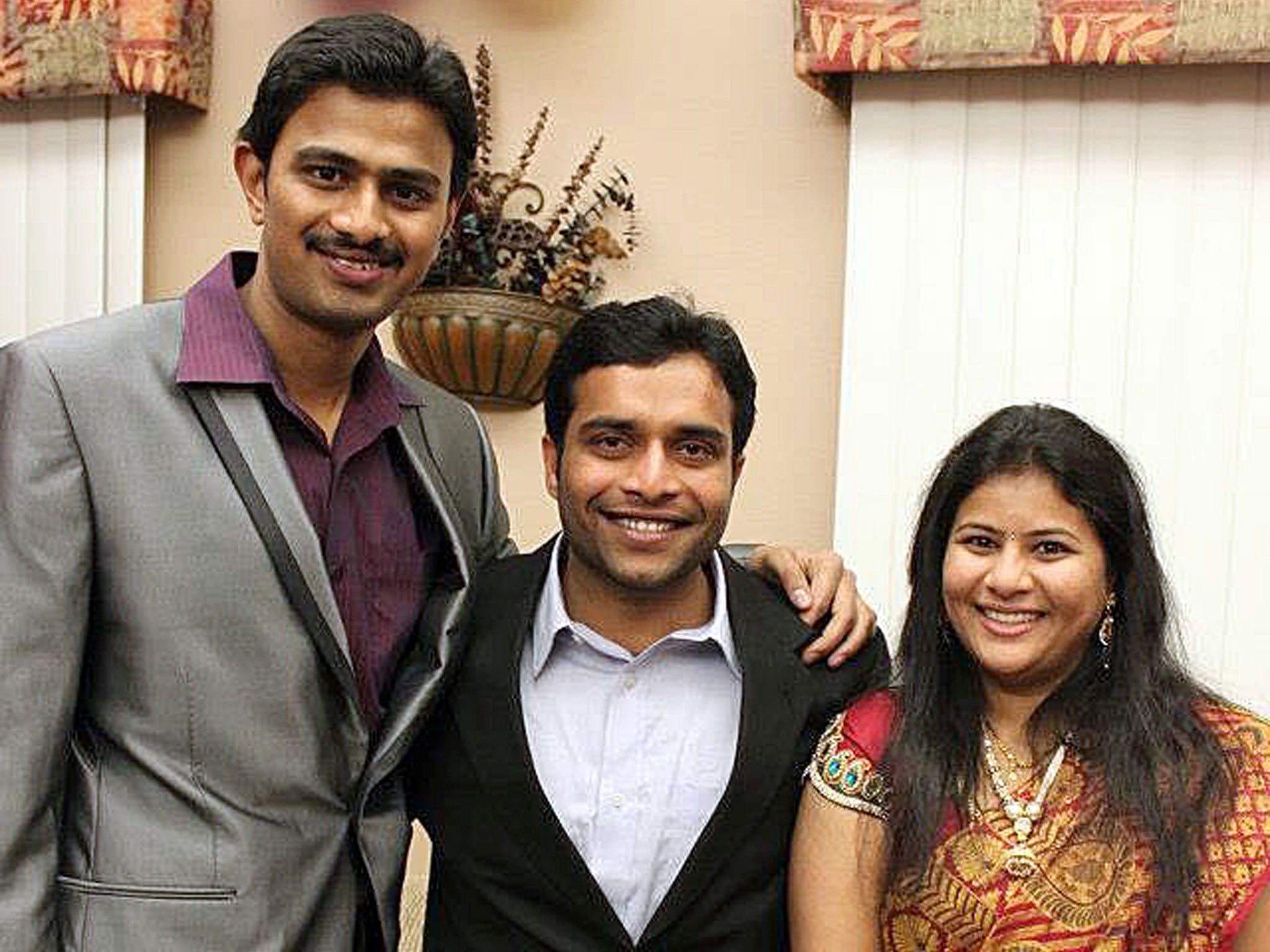 Srinivas Kuchibhotla, left, poses for photo with Alok Madasani and his wife Sunayana Dumala in Cedar Rapids, Iowa.