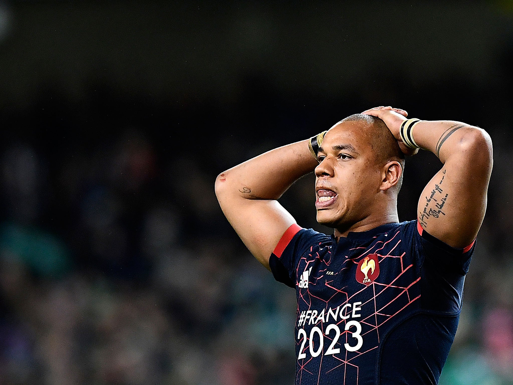 France's center Gael Fickou reacts after defeat