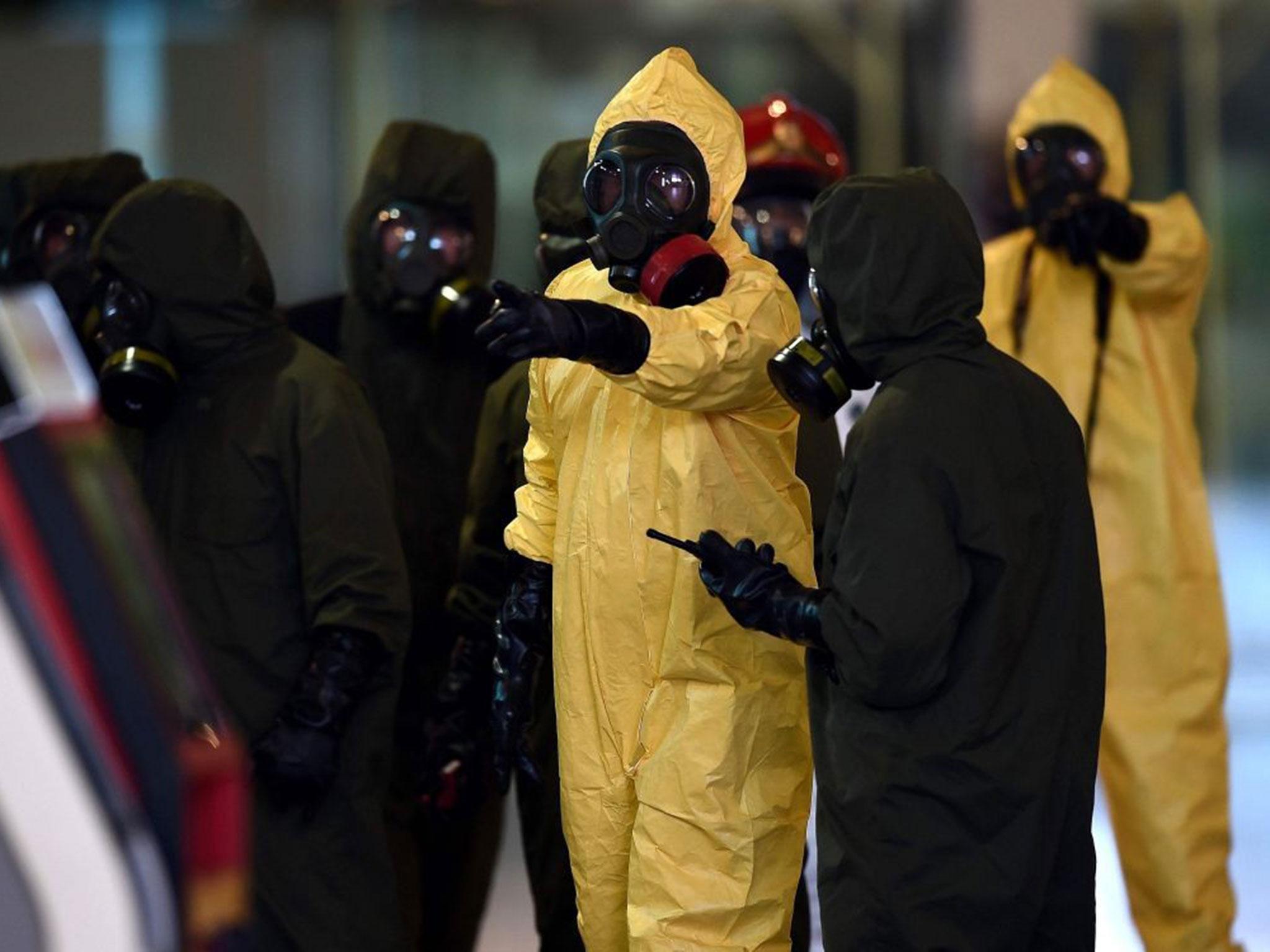 Members of Malaysia's hazmat team conduct a decontamination operation within Kuala Lumpur International Airport 2