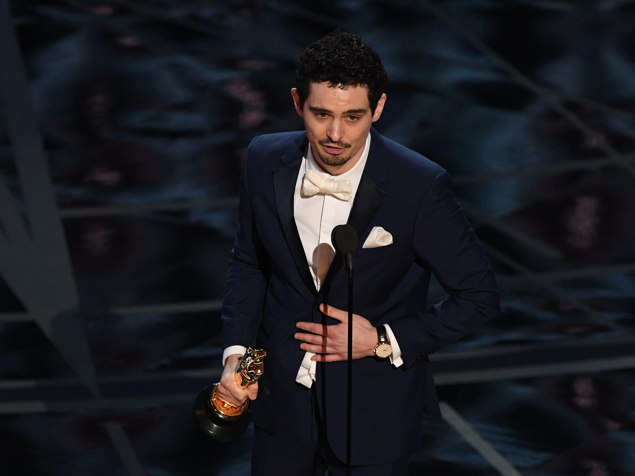 Director Damien Chazelle delivers a speech on stage after he won the Best Director award for "La La Land"at the 89th Oscars