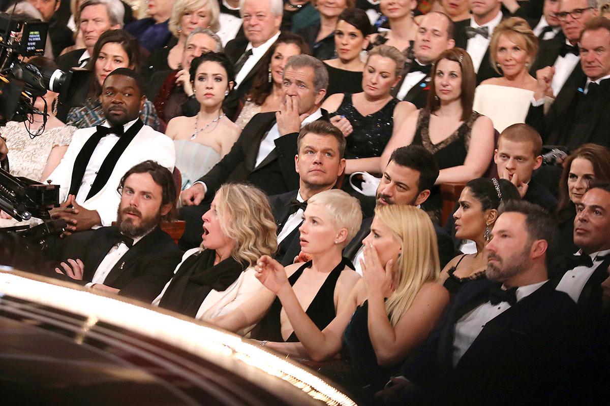 Stars on the front row react to the gaffe during the Oscars ceremony