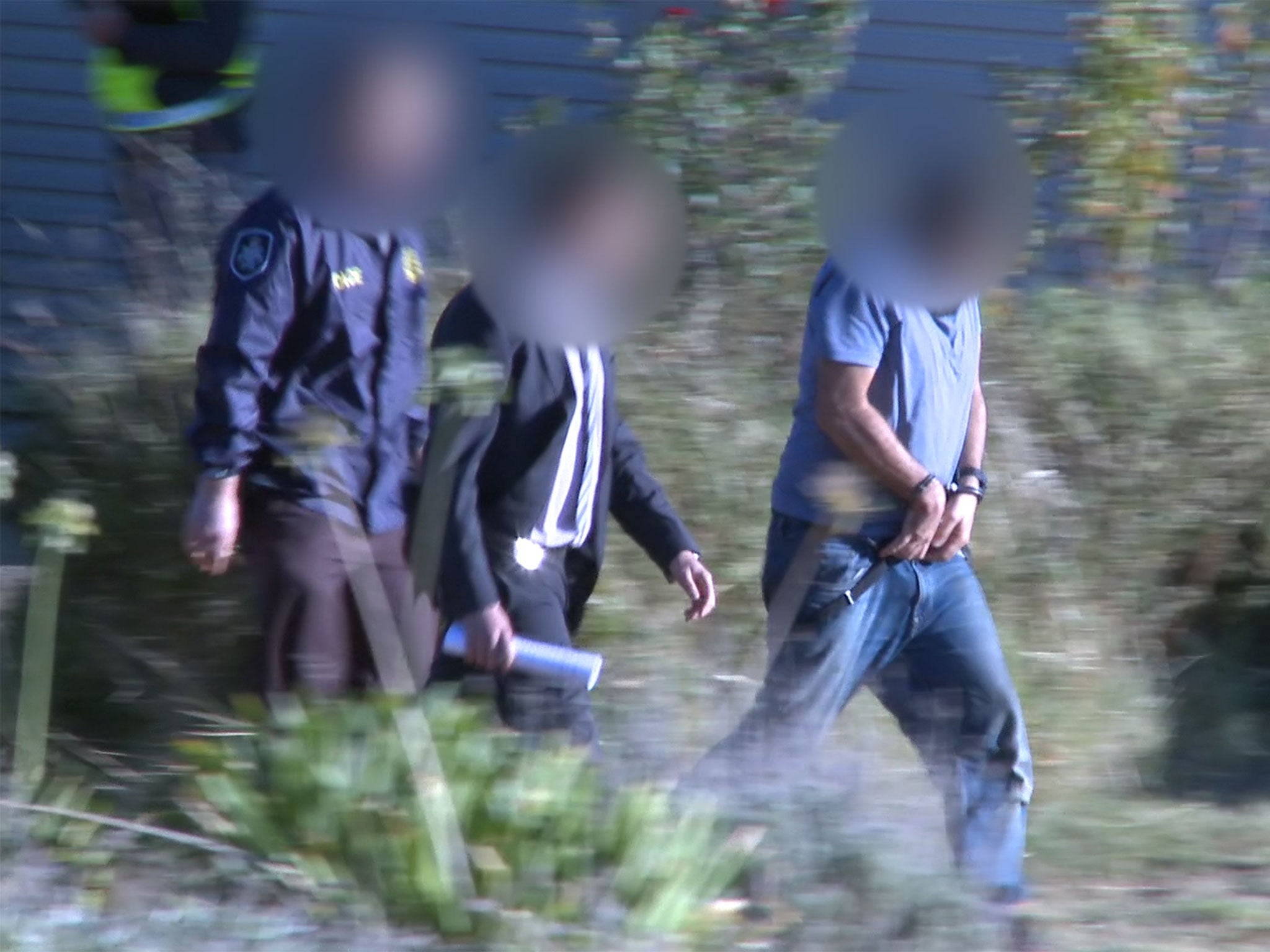 Haisem Zahab, 42, being arrested by counter-terror police at his home in Young, Australia, on 28 February