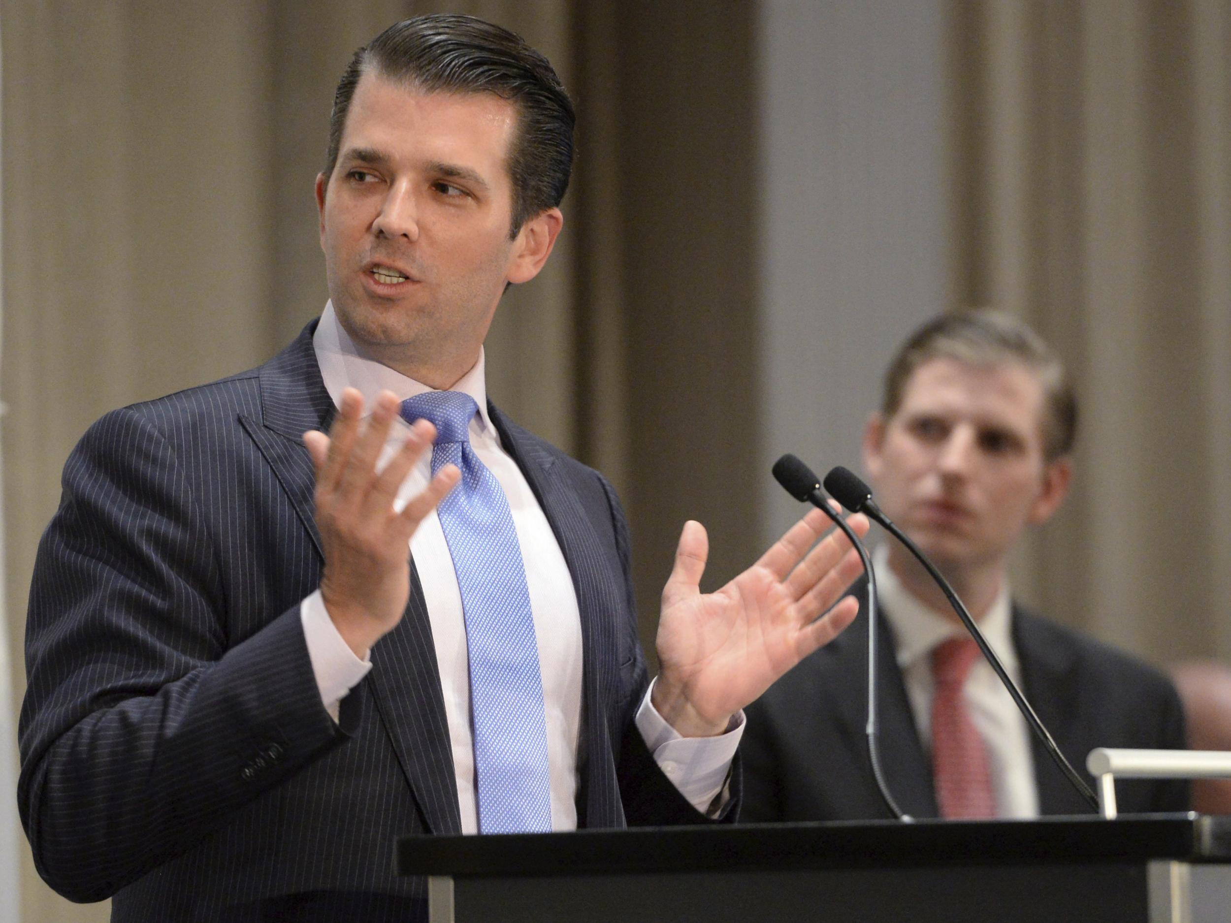 Donald Trump Jr., left, speaks as his brother Eric looks on during speeches at the grand opening of the Trump International Hotel and Tower in Vancouver