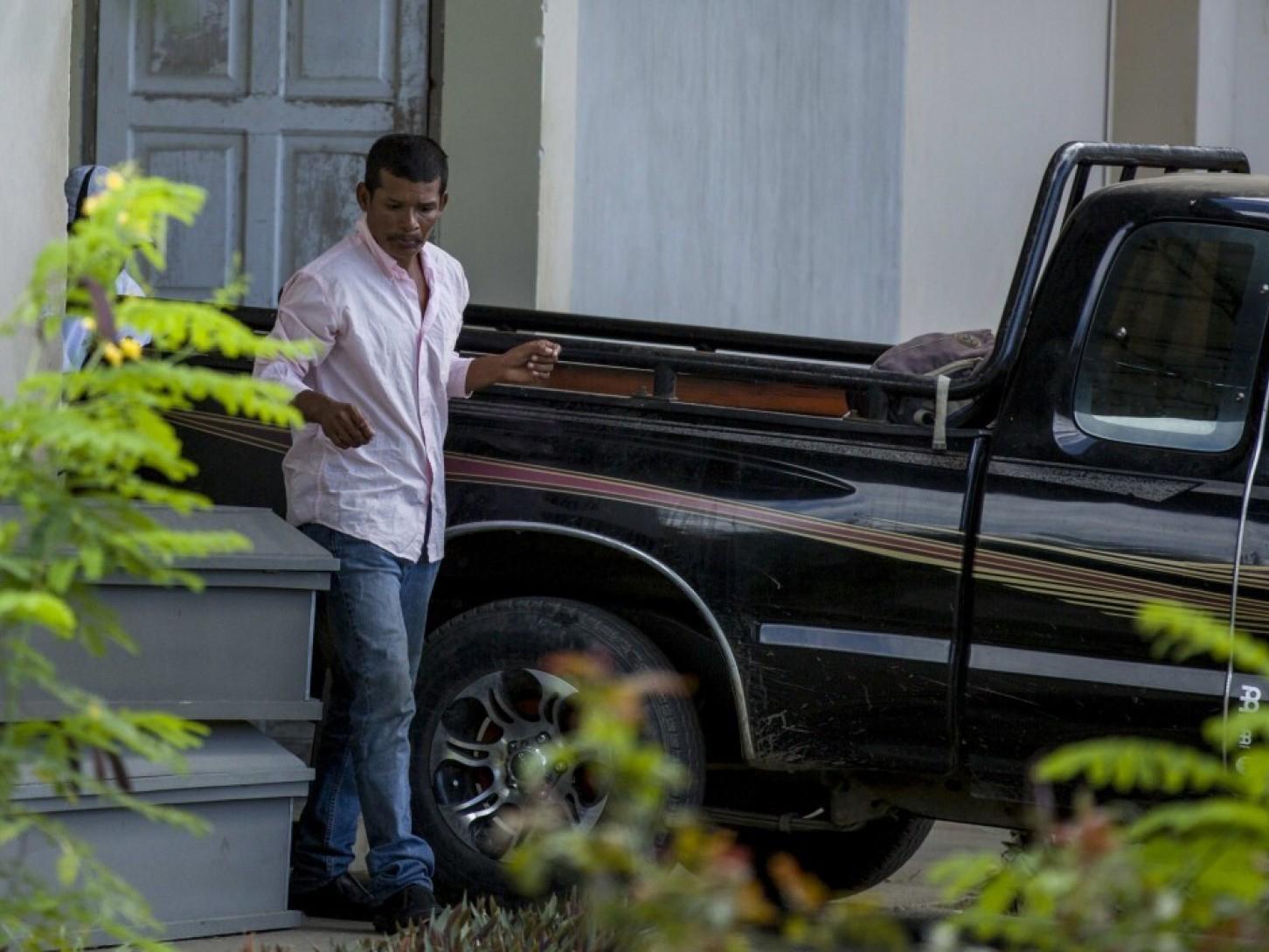 Reynaldo Peralta Rodriguez leaves the morgue with the coffin of his wife, Vilma Trujillo, who was burned in a bonfire in Nicaragua