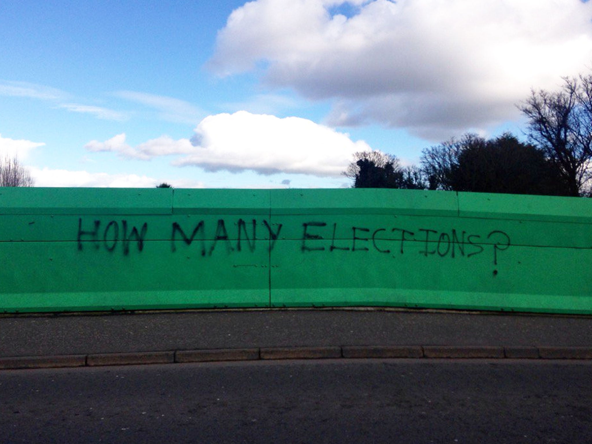 On the Finaghy Bridge, which links Andersonstown with the more affluent Finaghy village, one local has scrawled a protest message in black spray paint