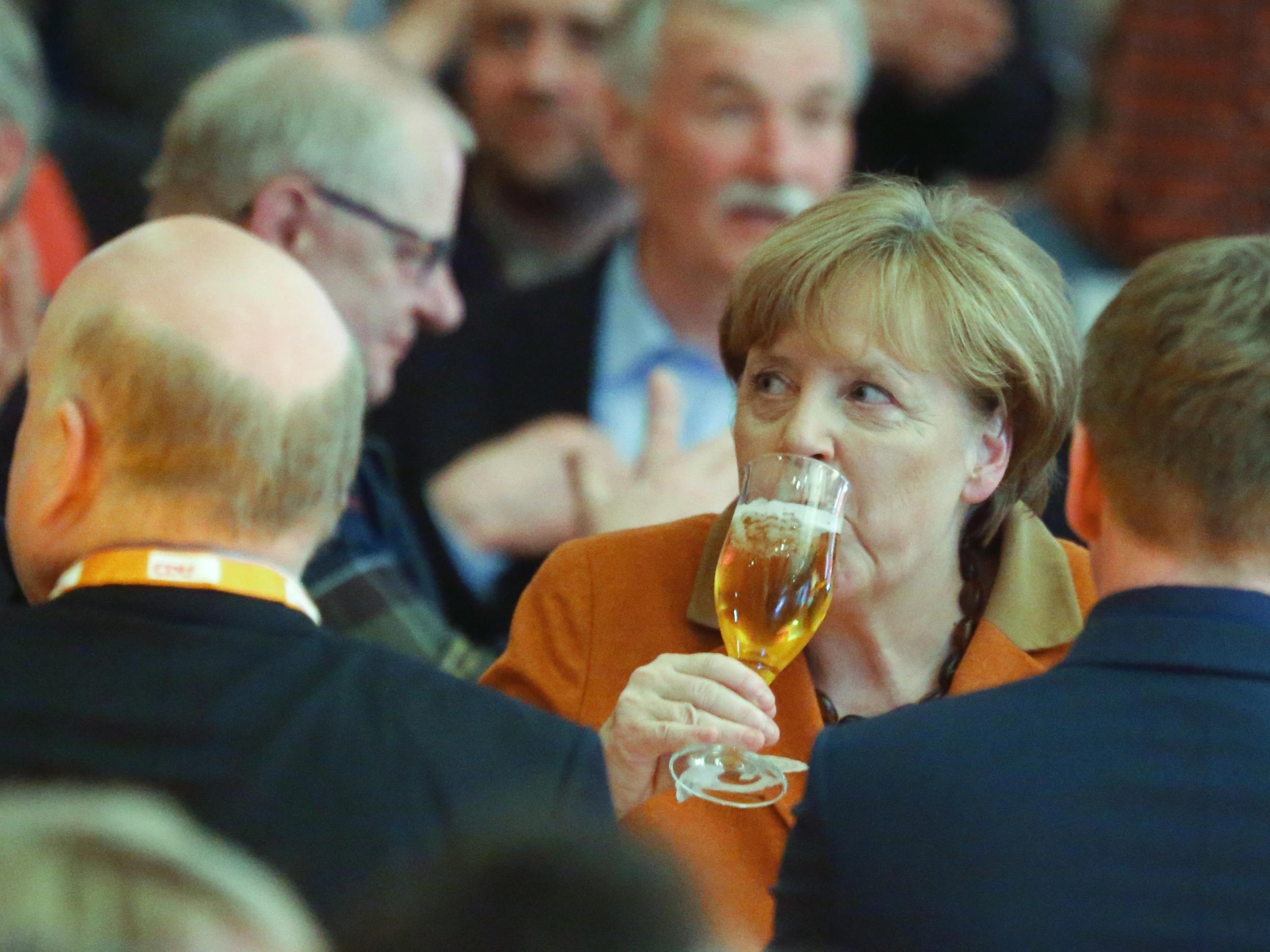 German Chancellor Angela Merkel drowns her sorrows during the political Ash Wednesday meeting of the Christian Democratic Union party in Demmin