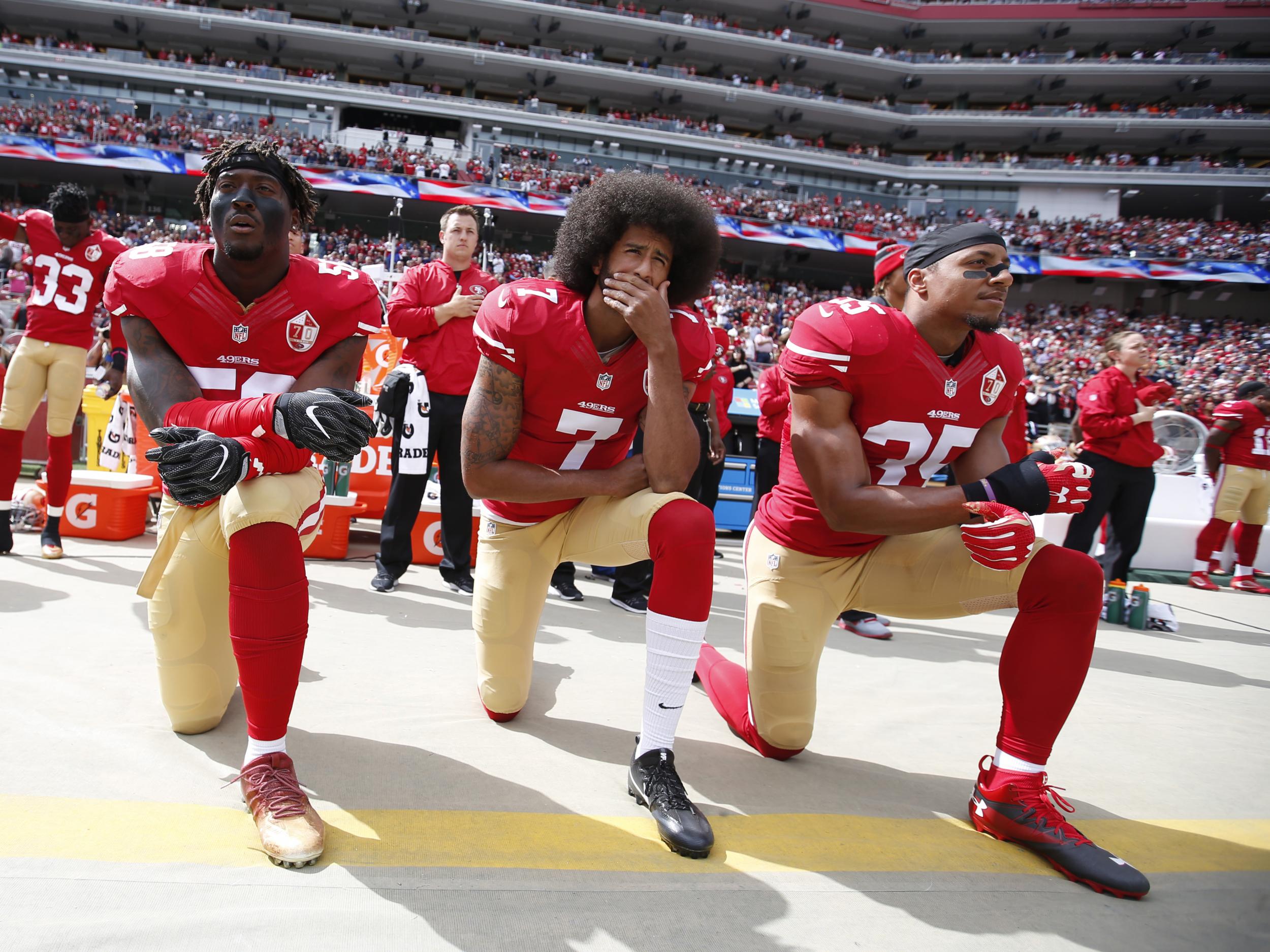 Kaepernick takes a knee prior to the game against the Dallas Cowboys