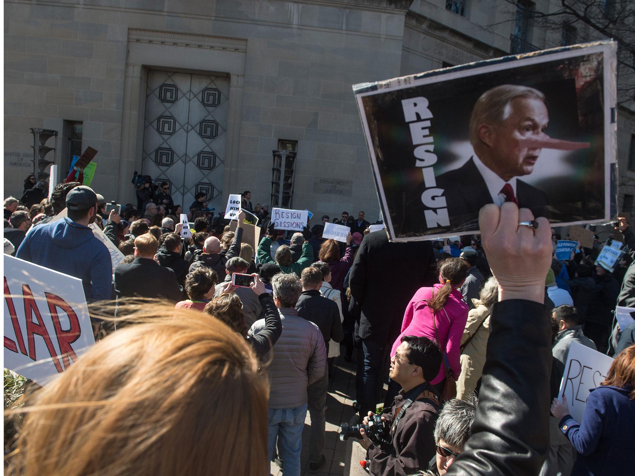 Protesters called for Mr Sessions' resignation in front of the justice department in Washington