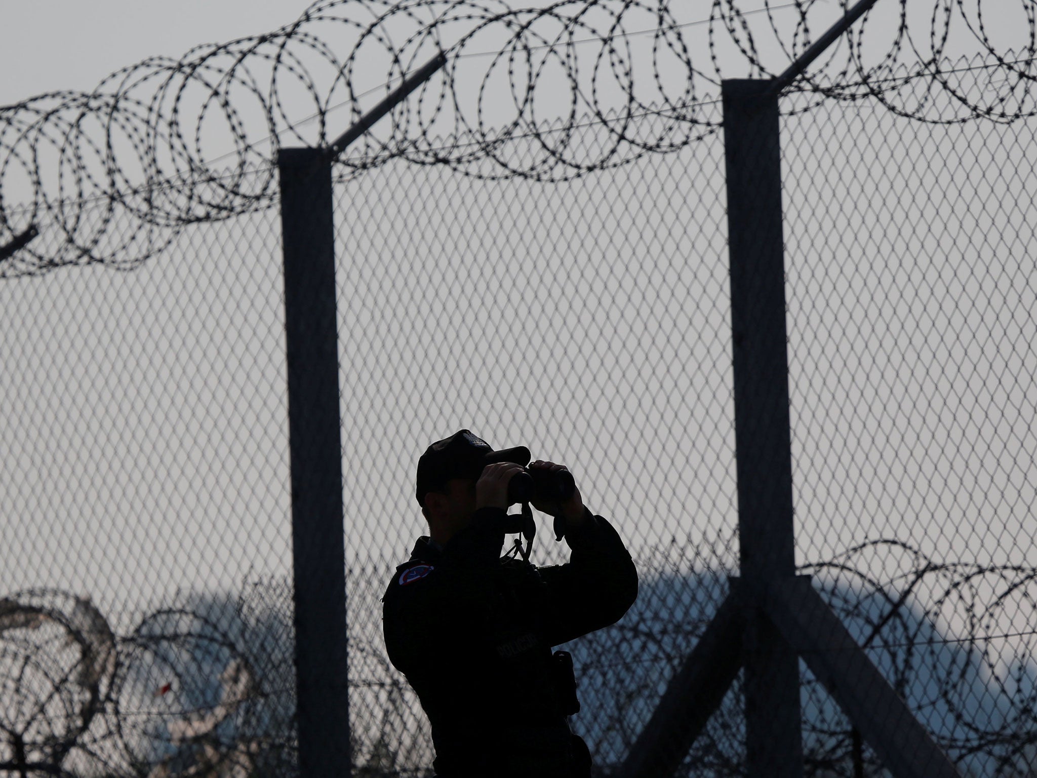 A policeman patrols the area at the Hungary and Serbia border fence near the village of Asotthalom, Hungary October 2, 2016.