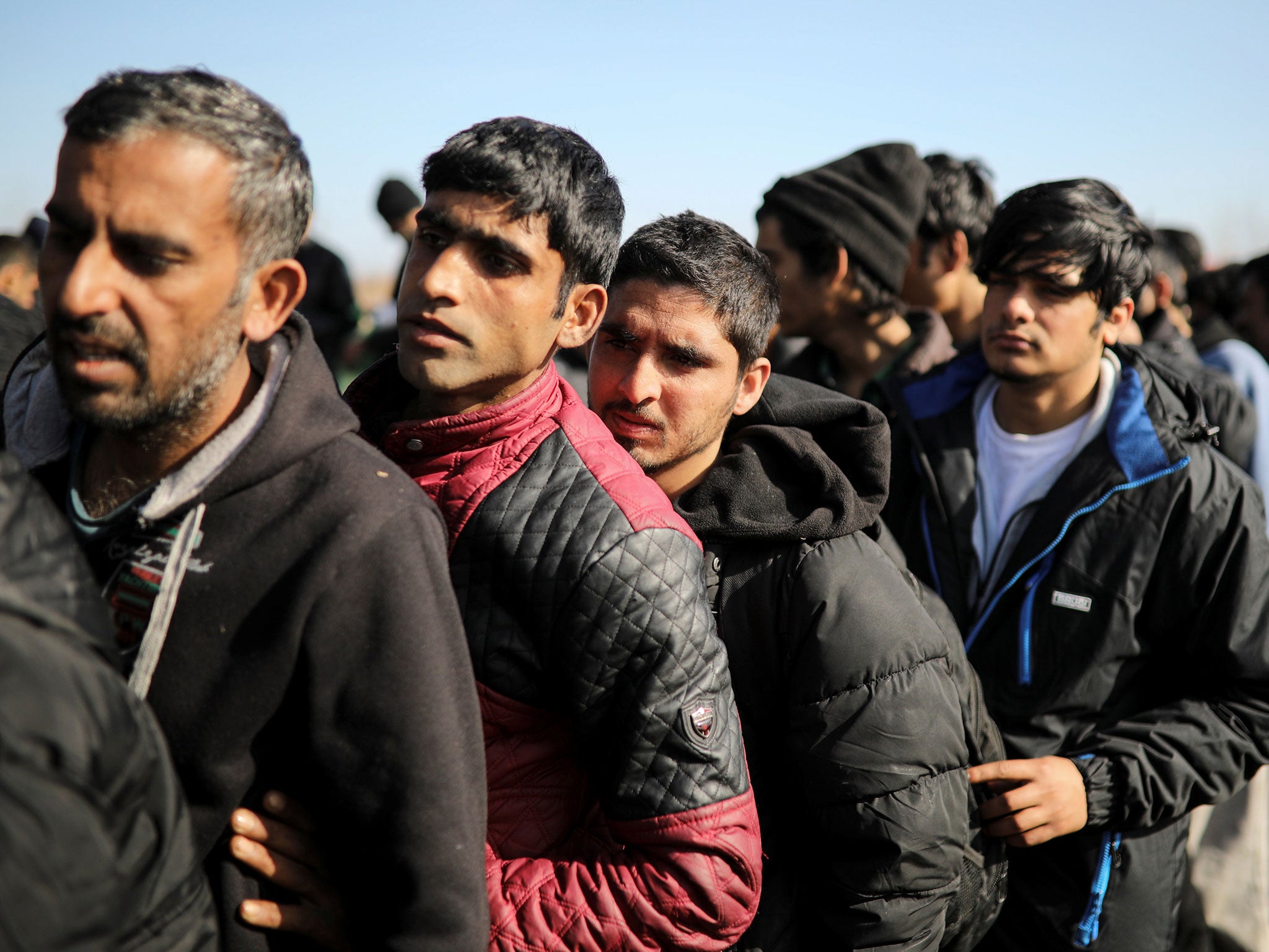 Migrants wait to receive free food near the Serbian-Hungarian border outside the town of Subotica, Serbia March 3, 2017.