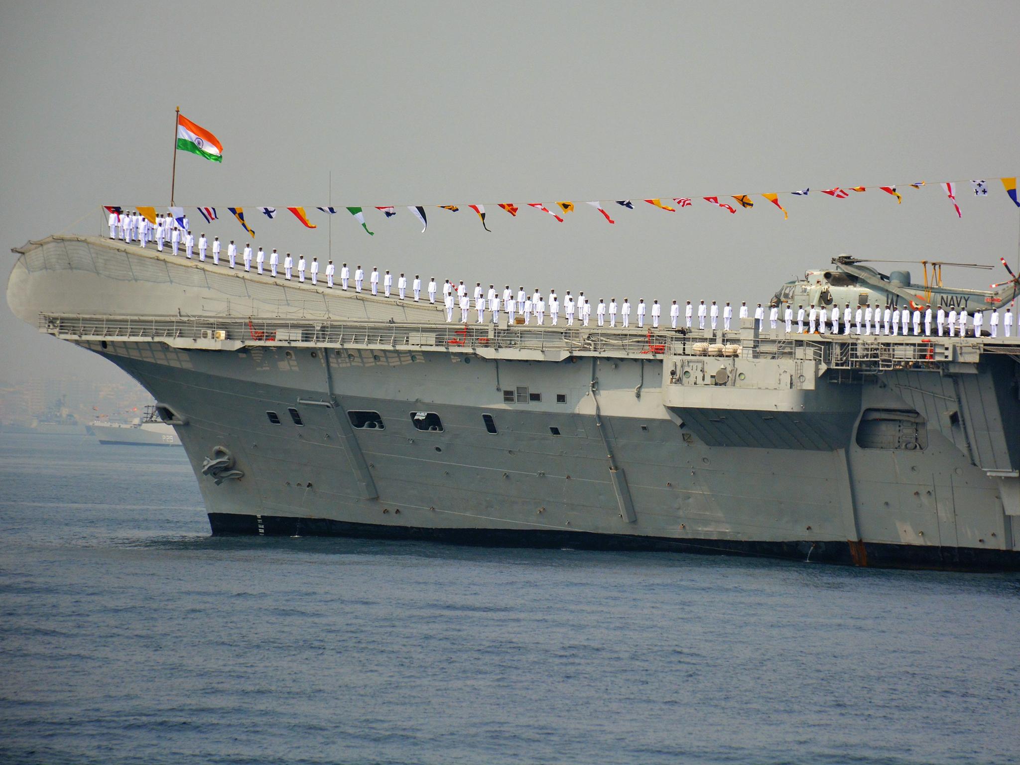 Indian Navy personnel stand on the INS Viraat, a centaur-class aircraft carrier, during the International Fleet Review in Visakhapatnam