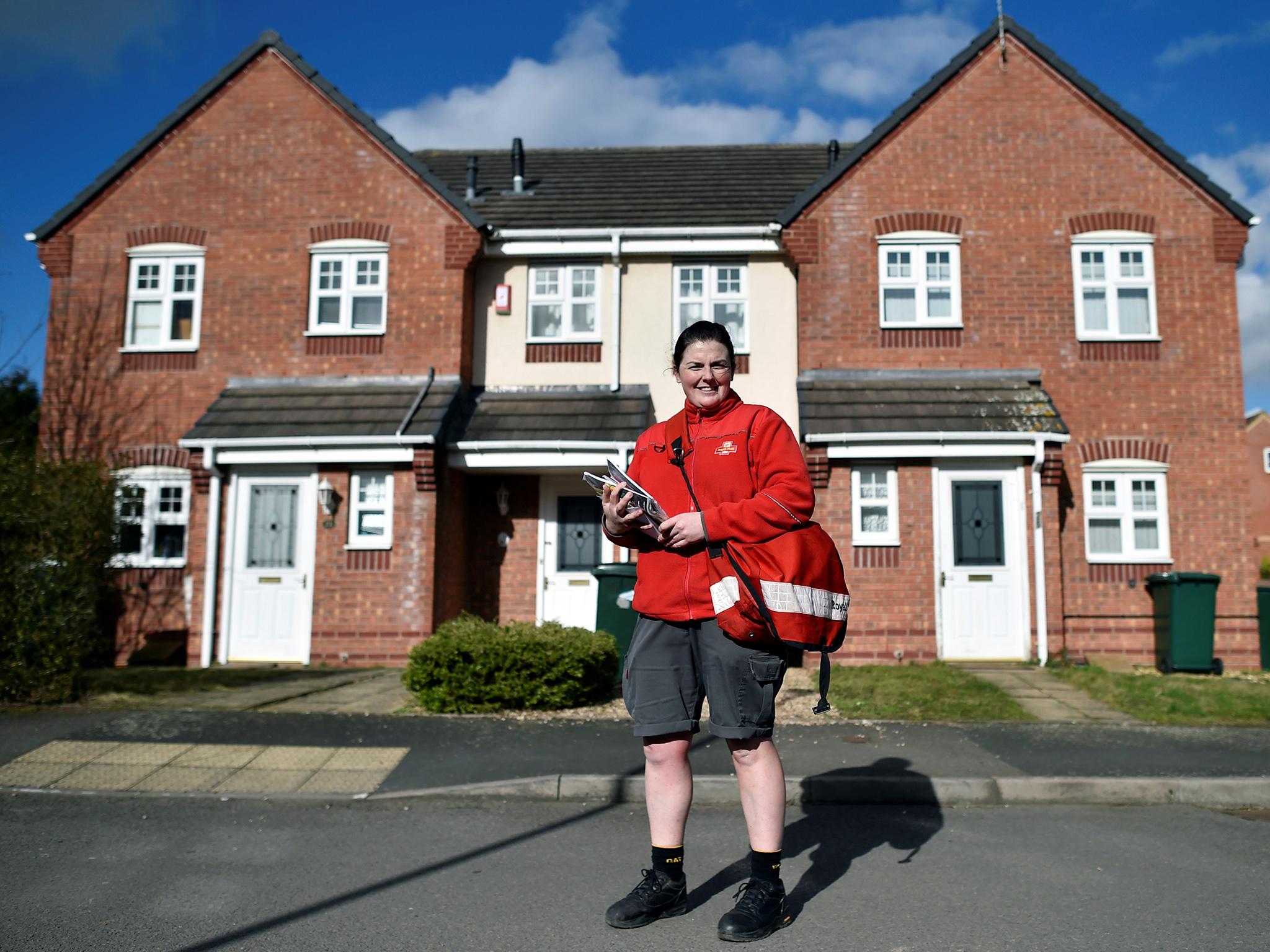 Cilene Connolly, 32, a Royal Mail postwoman, poses for a portrait during her postal round. "Fortunately, I haven't been faced with gender inequalities in my role as a postwoman," Connolly said. "I've had a great response from my customers for being a female delivering their post, women in particular are always pleasantly surprised to see a female face."
