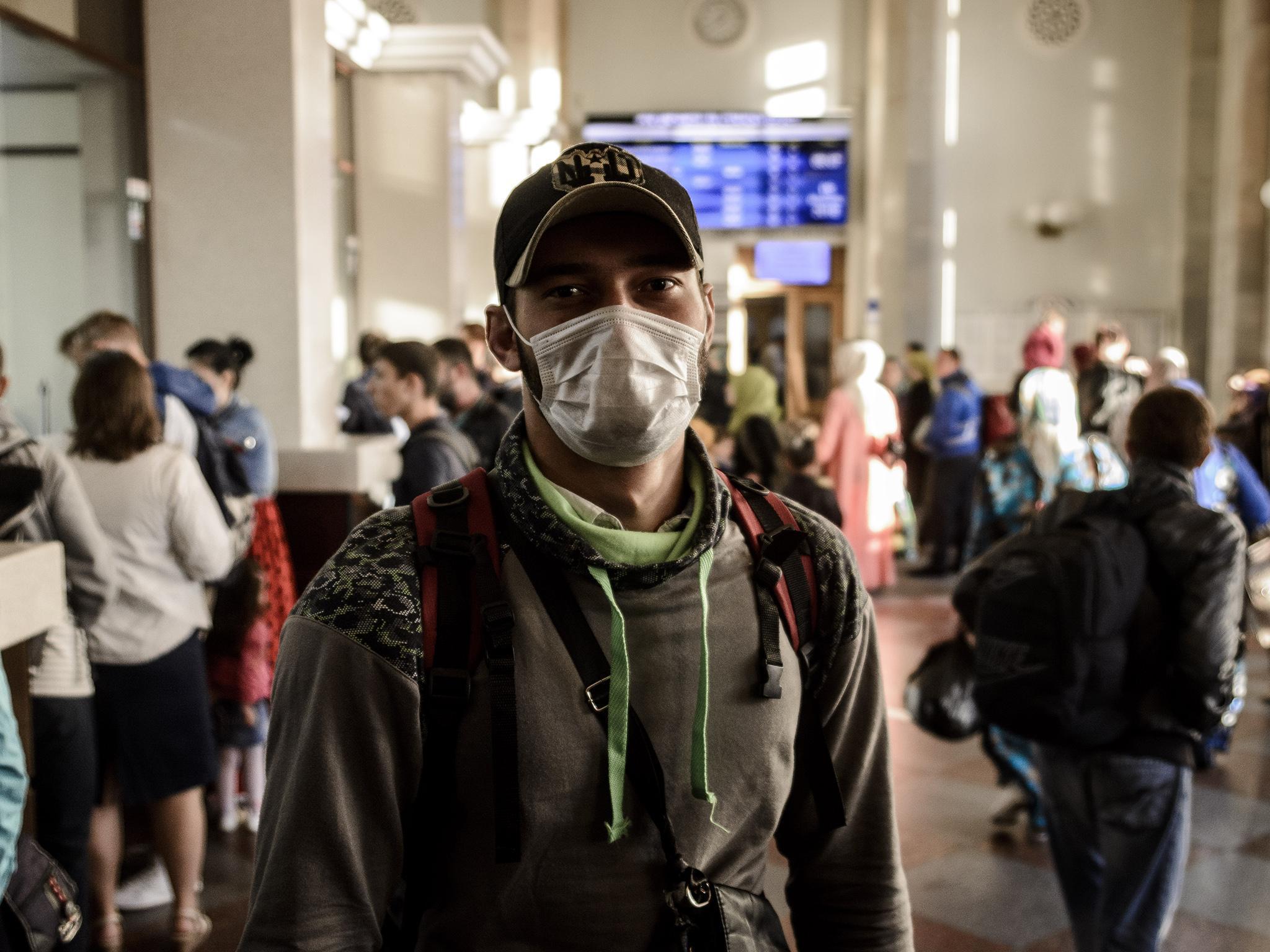 Hundreds of Chechens crowd the train station’s departures hall. Some wear masks to hide their identity from police and the press