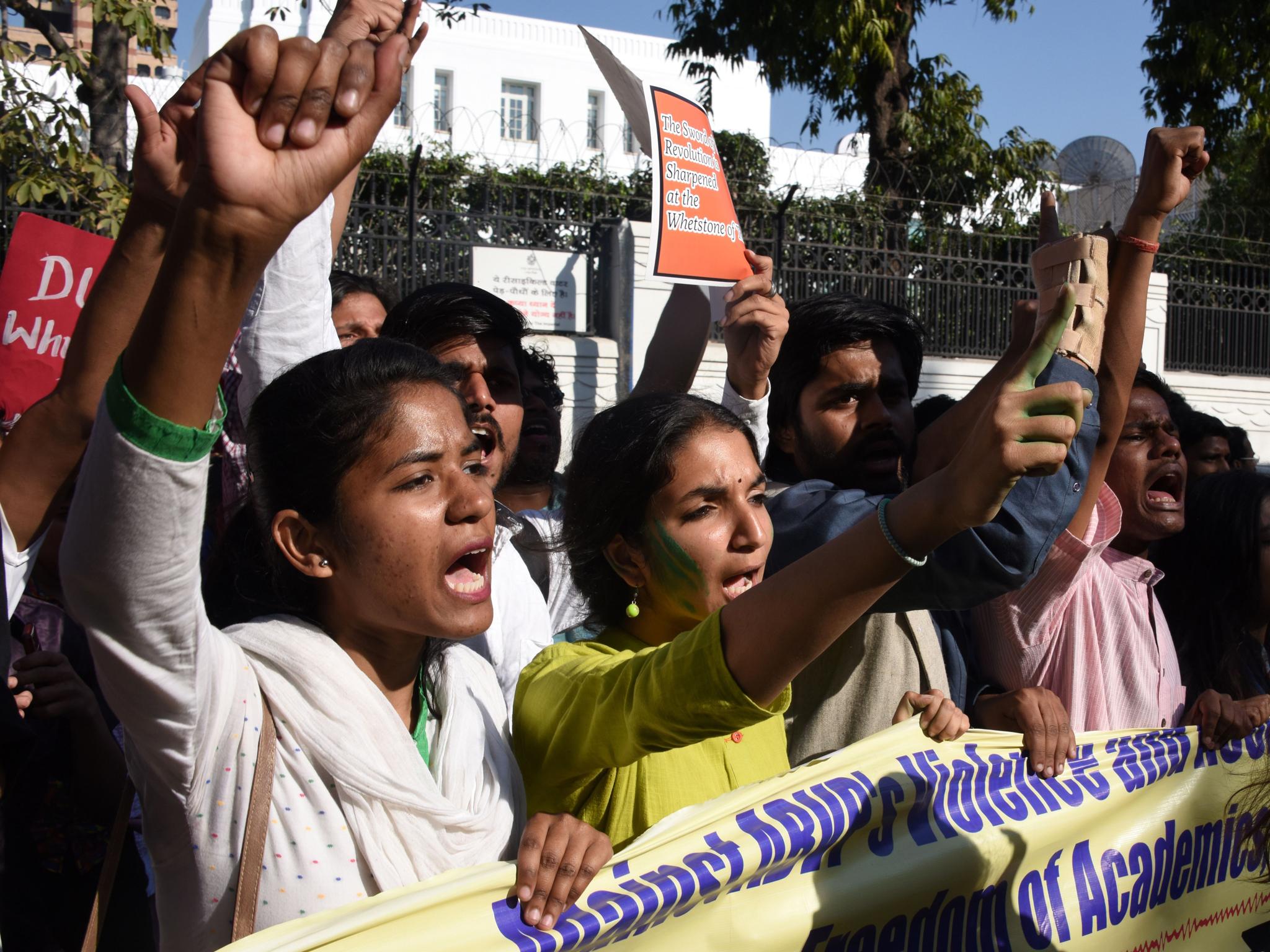 Indian students from Delhi University and Jawaharlal Nehru University shout slogans as they march behind a banner during a rally in New Delh