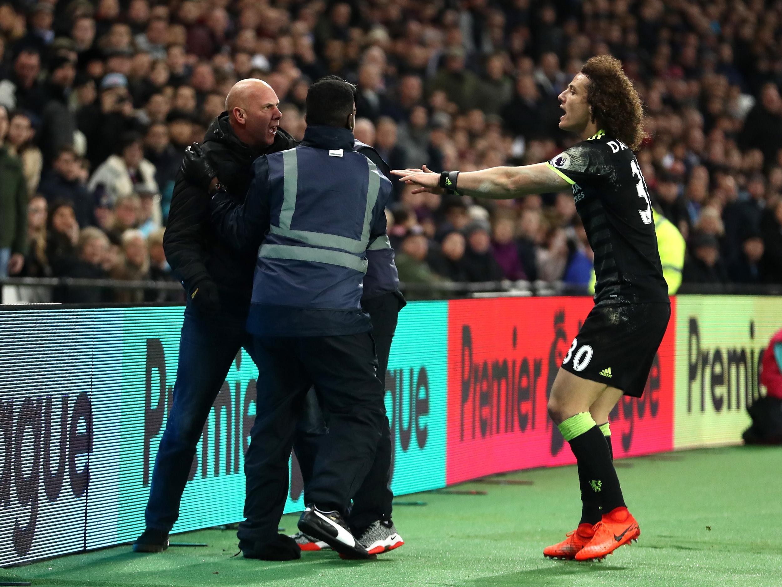 The supporter was wrestled away from Chelsea's players