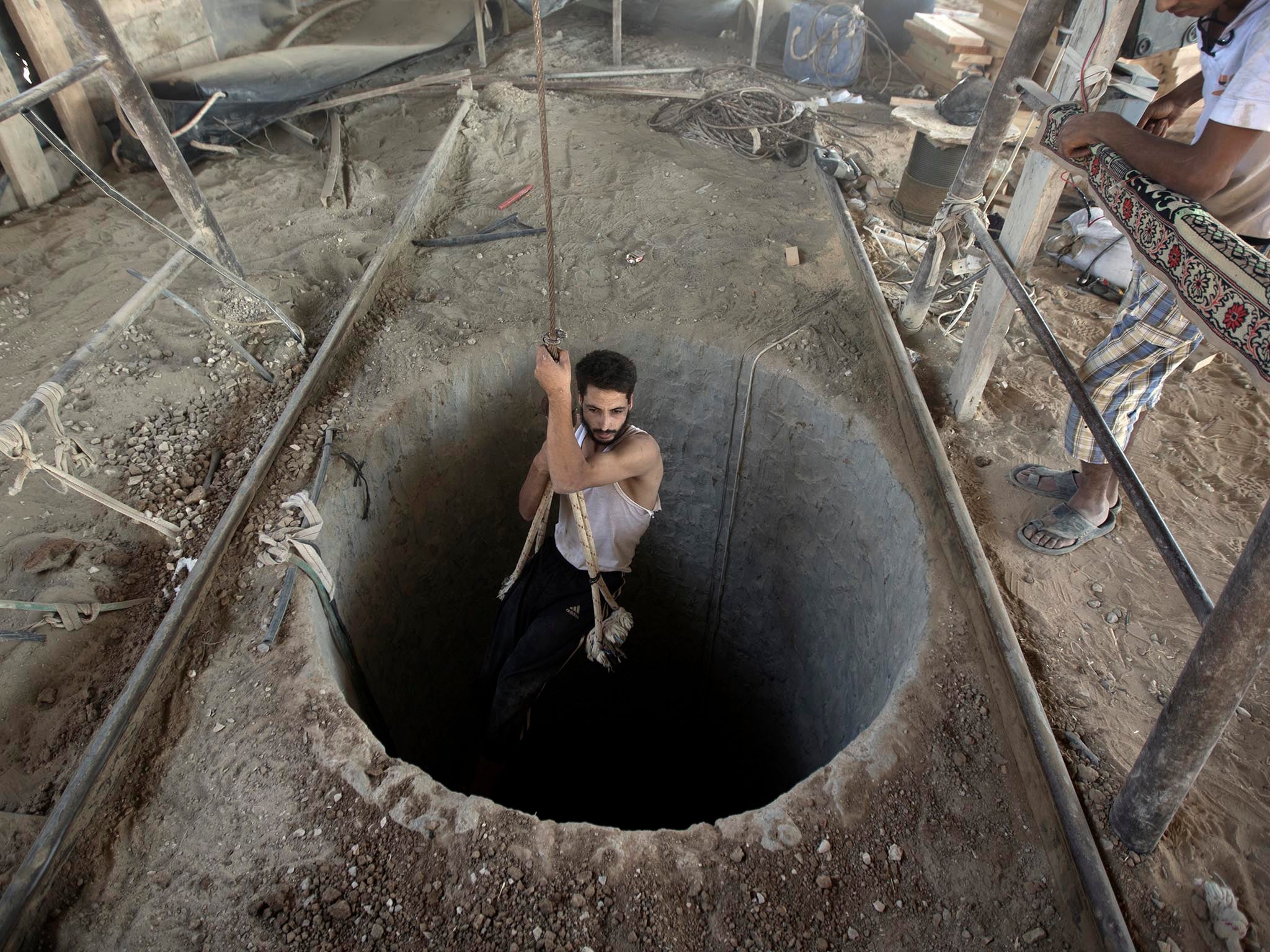 A Palestinian man being lowered into a smuggling tunnel beneath the Gaza-Egypt border in 2013. The tunnels were destroyed by the Egyptian government in 2014 and 2015