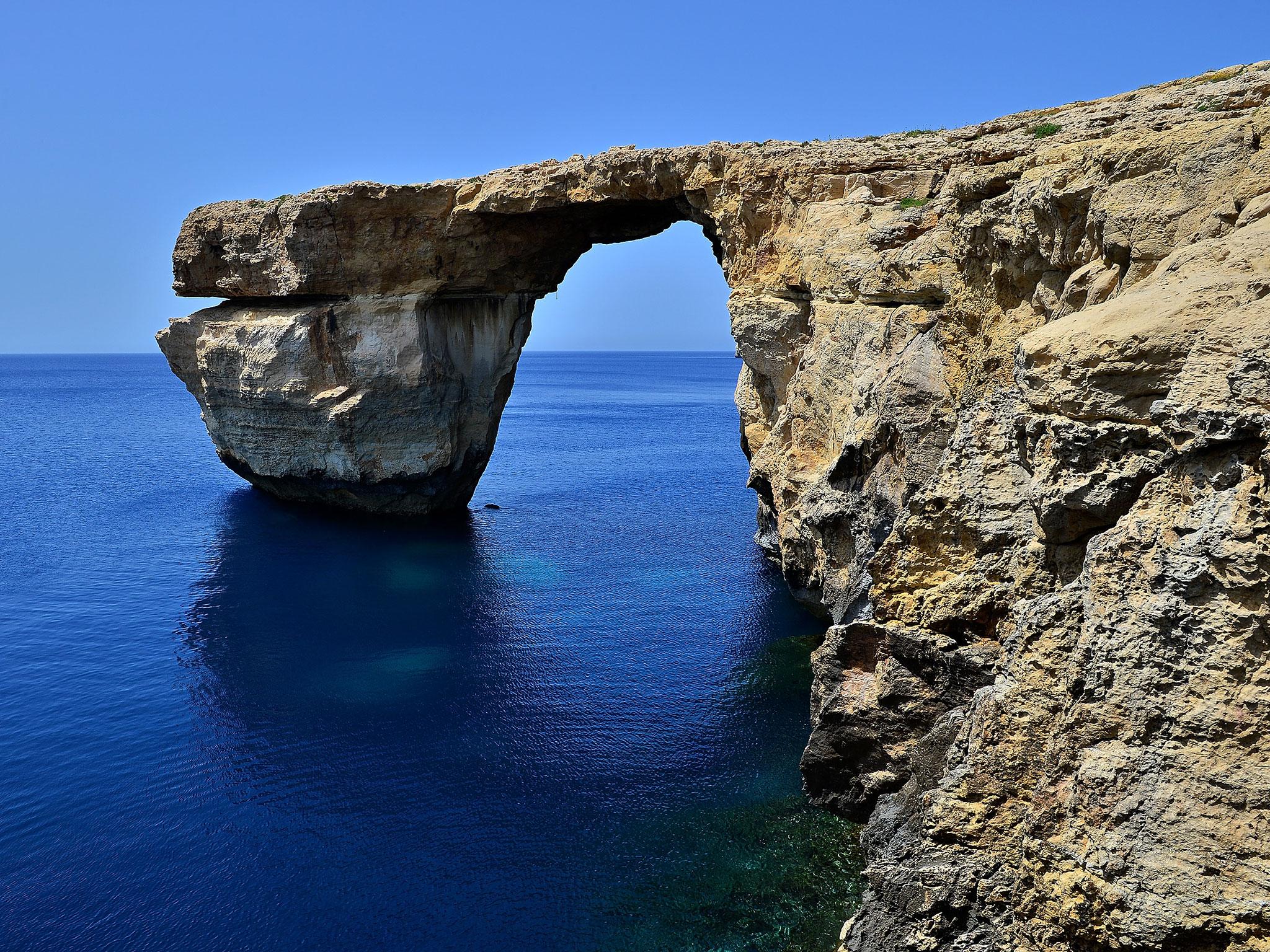 The Azure Window arched over blue seas popular with divers and featured in countless tourism brochures